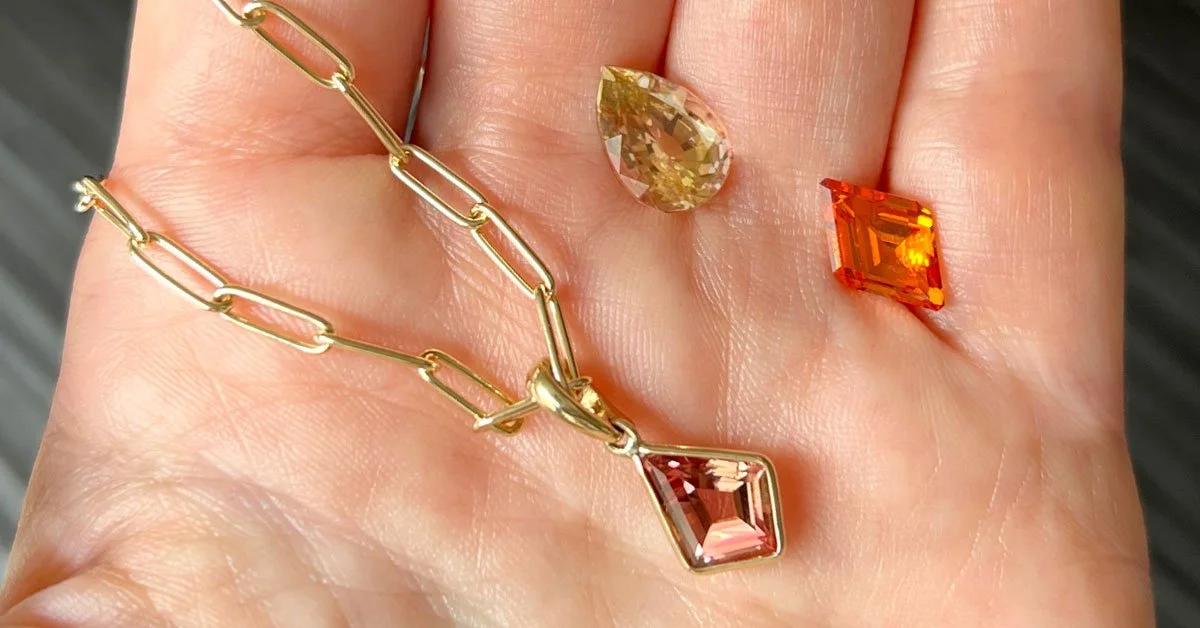 colored-gemstone-layering-necklace-with-gems-on-hand.jpg