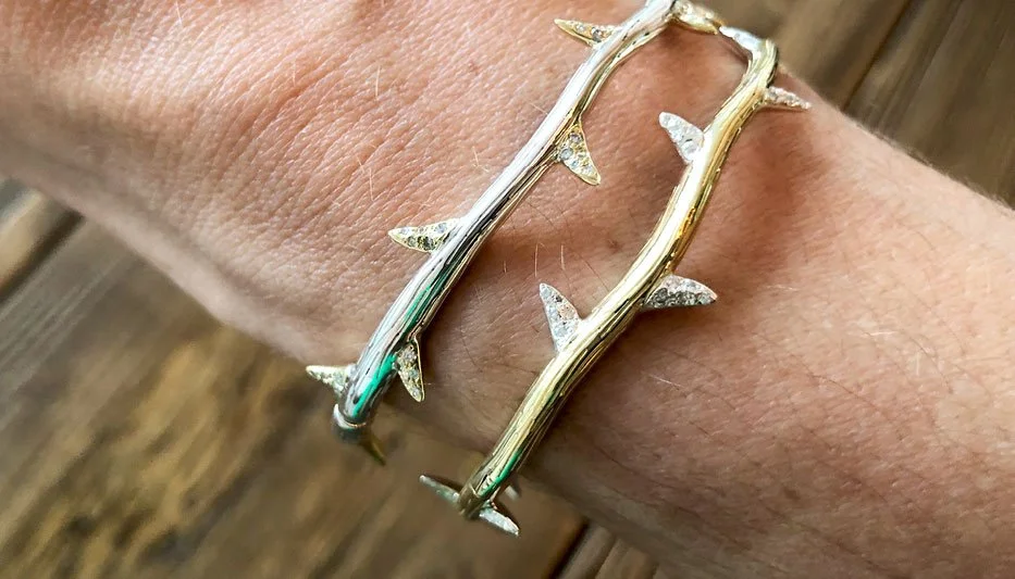 hinged bangle bracelet in gold with diamond thorns on woman's wrist