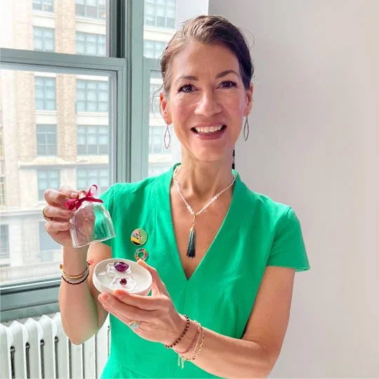 Woman presenting investment-quality gemstones and jewelry