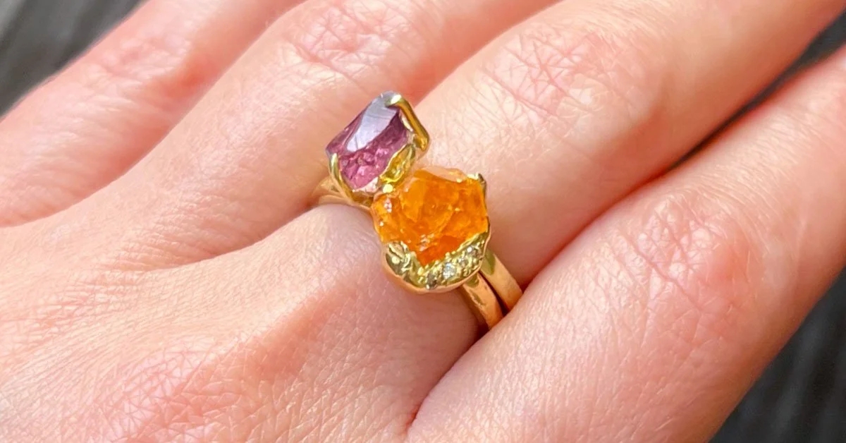 purple-orange-gemstone-stacking-rings-on-womans-hand.jpg