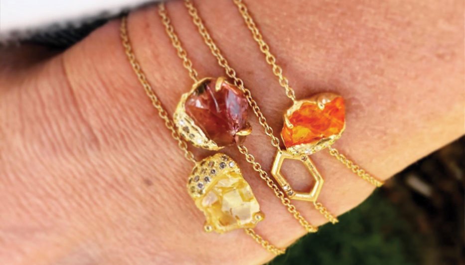 bolo bracelet in gold with gemstone bracelet stack on woman's wrist