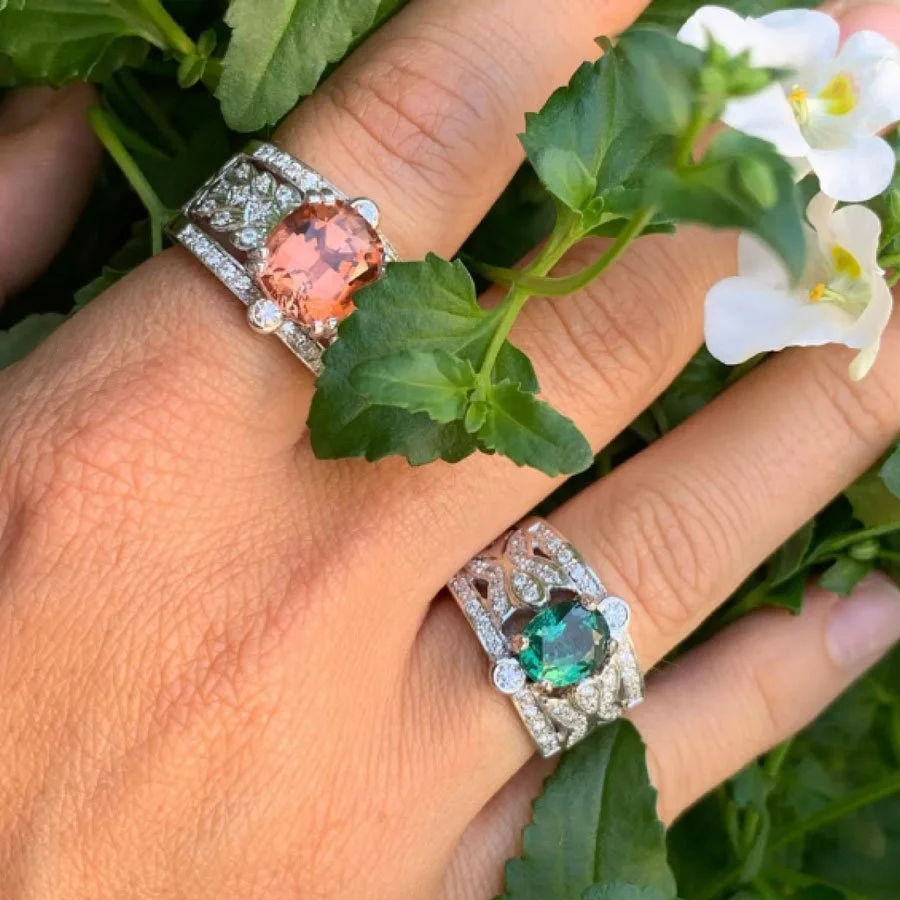 Close up of a woman's hand wearing colored gemstone rings
