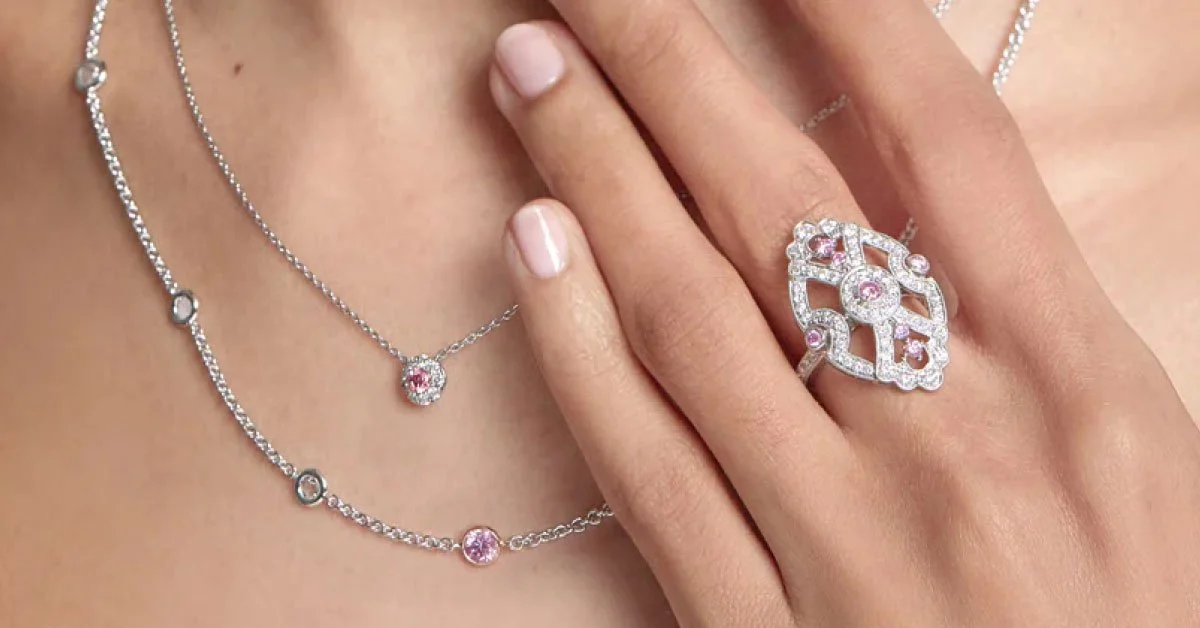 pink-diamond-layering-necklaces-and-ring-on-womans-neck-and-hand.jpg