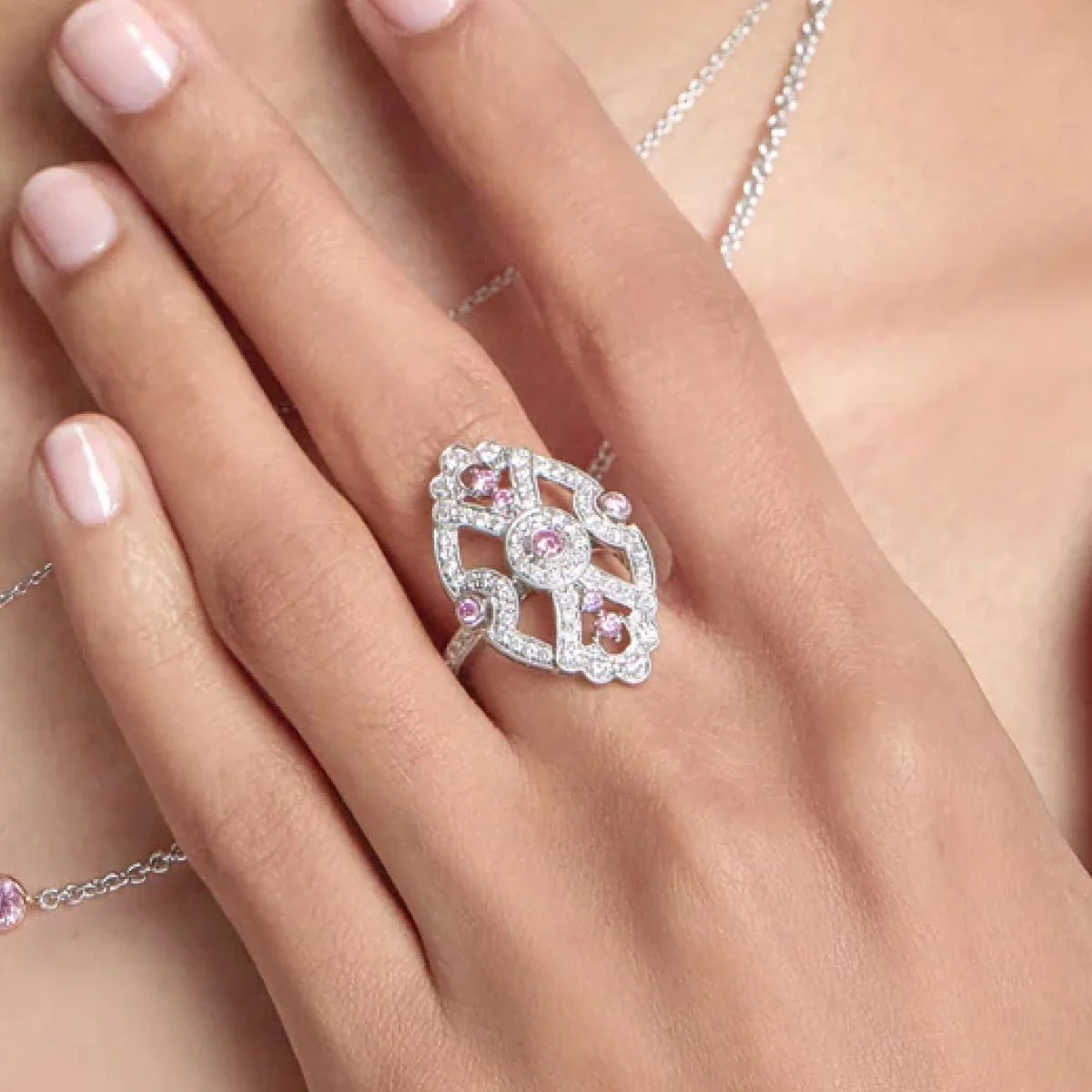 Pink diamond cocktail ring worn on a woman's hand