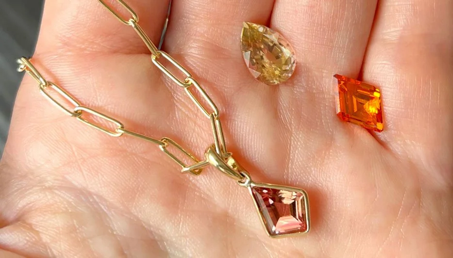 warm-hued gemstone necklace with rare gemstone as bespoke options in hand