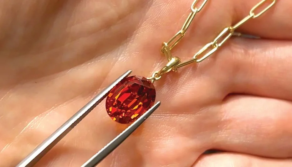bespoke red gemstone pendant idea on woman's hand