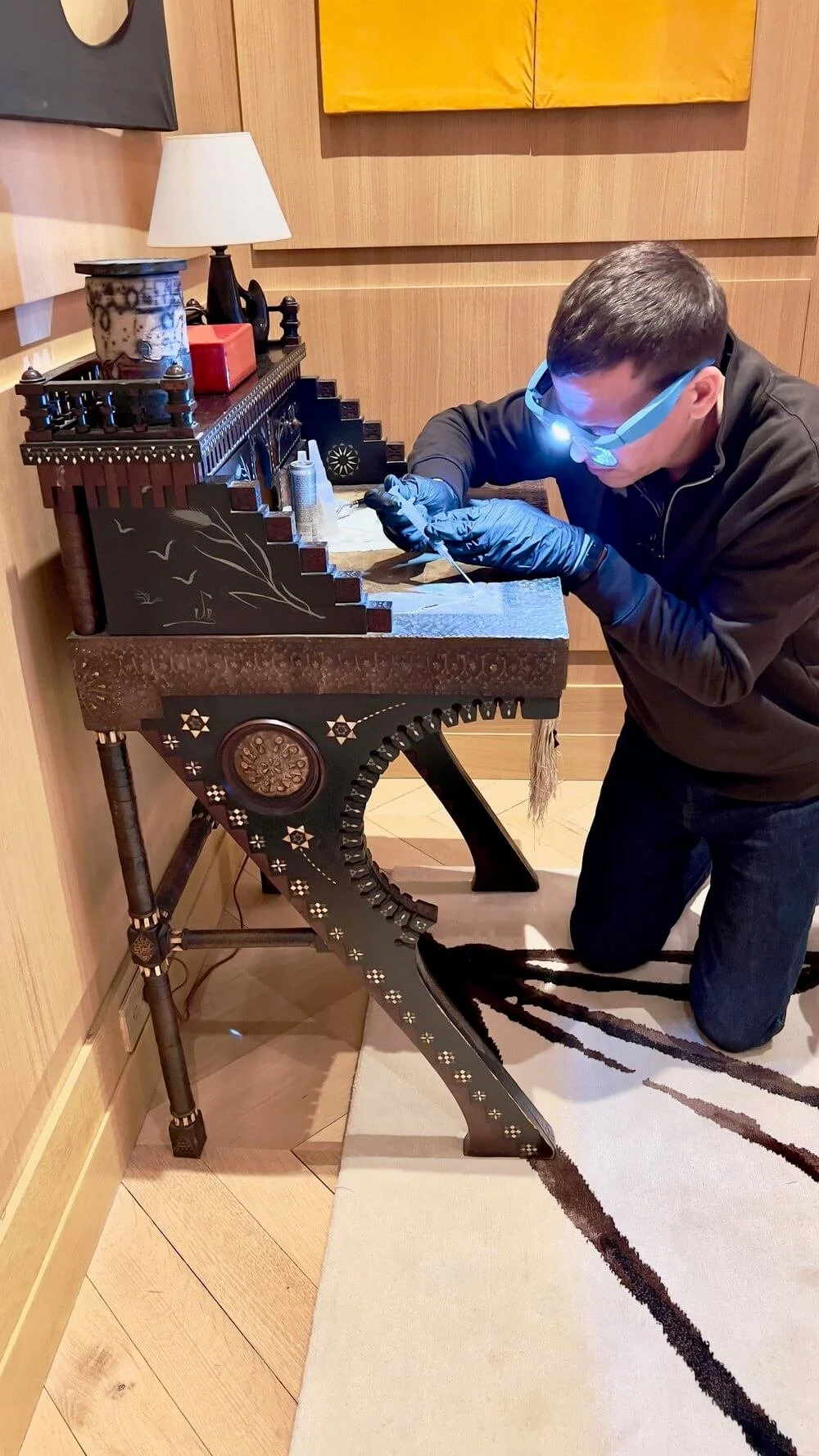 Austin Kerr restoring a Carlo Bugatti desk, demonstrating expert collectible design restoration techniques. Learn material selection, finishes, and conservation methods in his Materials in Design online course.