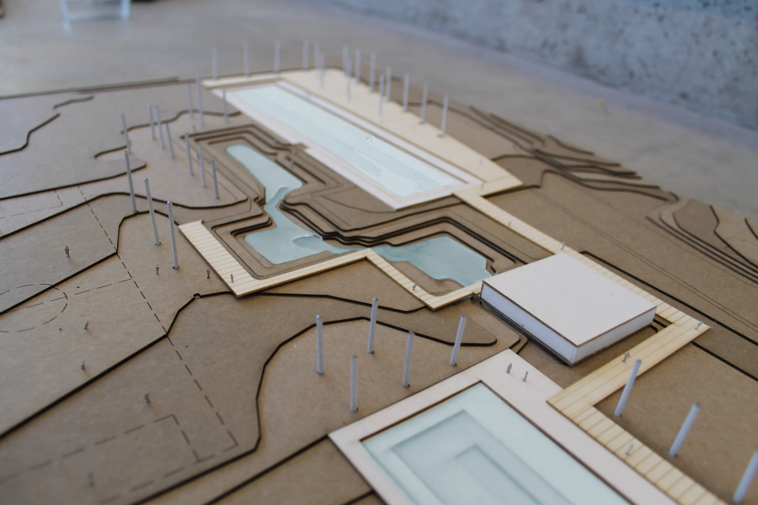 Architectural model of a water management plan with natural pools and landscaped areas.
