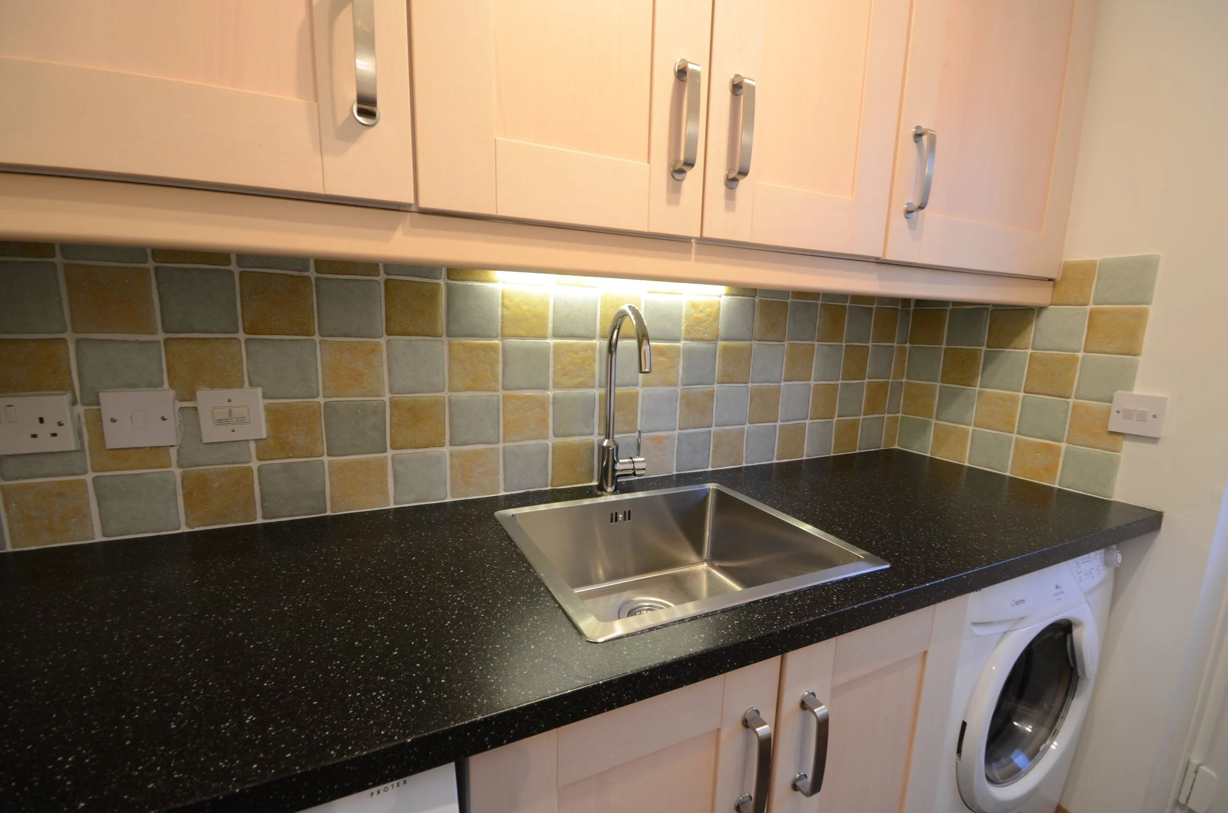 Interior tiles been made from white recycled glass and a mixture of yellow glass to create a marble effect on the yellow tiles.  