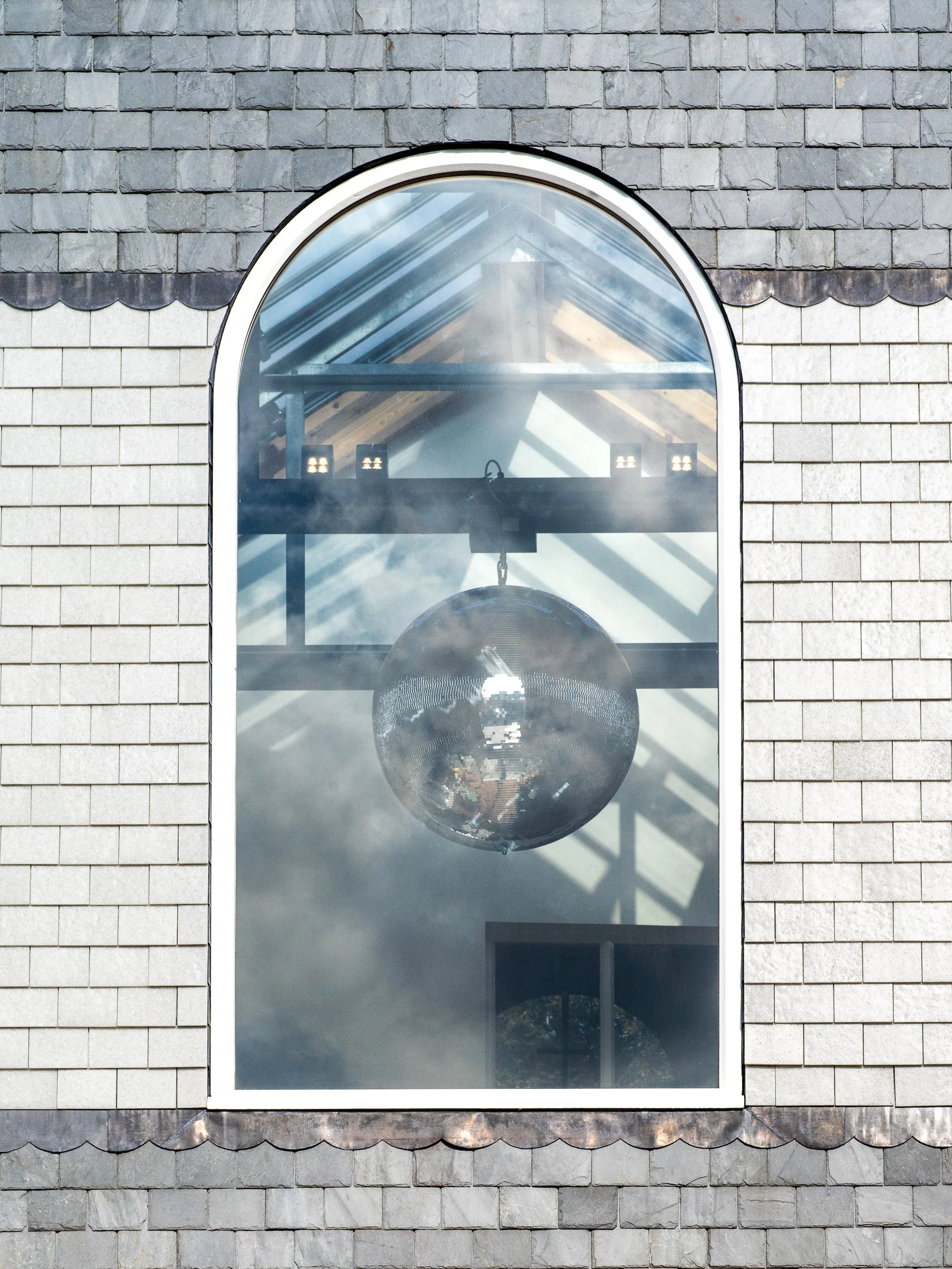 Close-up view of the recycled glass at the Buttermarket, showing a window framed by white recycled glass tiles and grey slate. Photo: Claire Fear
