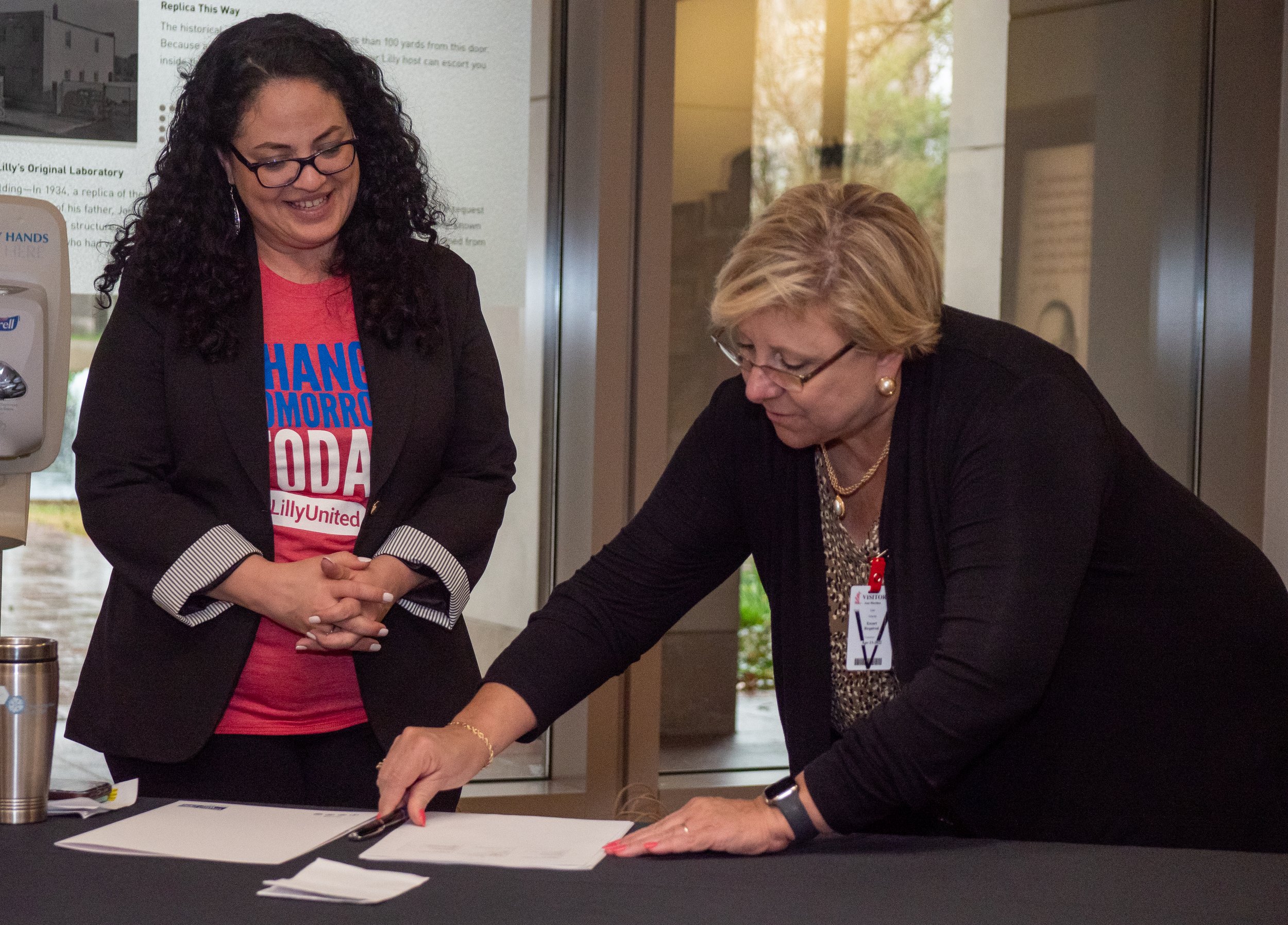  Cynthia Cardona (left), president of the Lilly Foundation and associate vice president of Social Impact at Eli Lilly and Company, and Ann Murtlow, former president and CEO of United Way of Central Indiana, sign a memorandum of understanding April 13