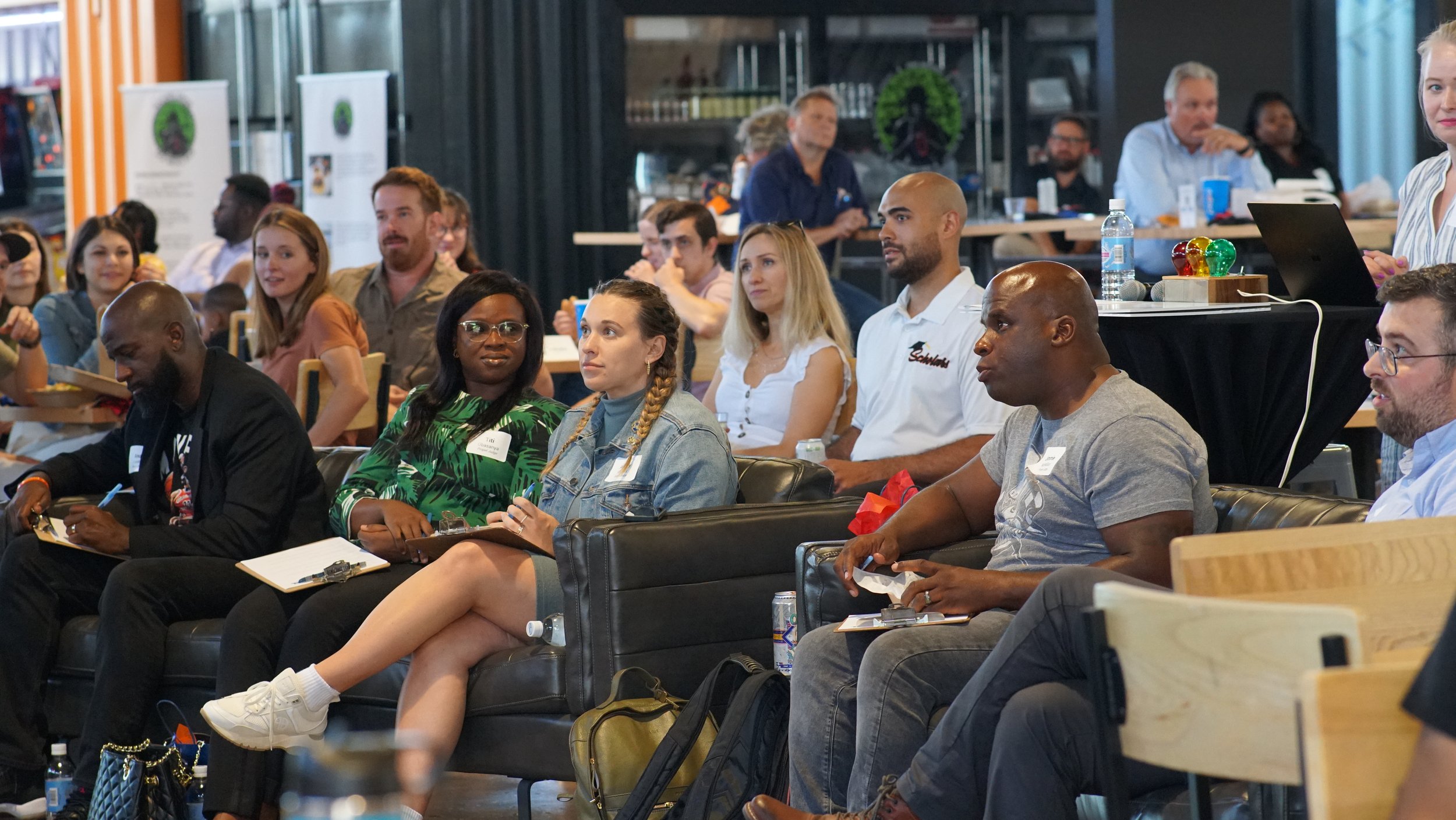 Seated in the front row, a panel of judges listens to pitches June 14, 2022, at Propel. At United Way’s live competition,  human services organizations pitched their ideas on how to reduce barriers for those from under-resourced communities and asse