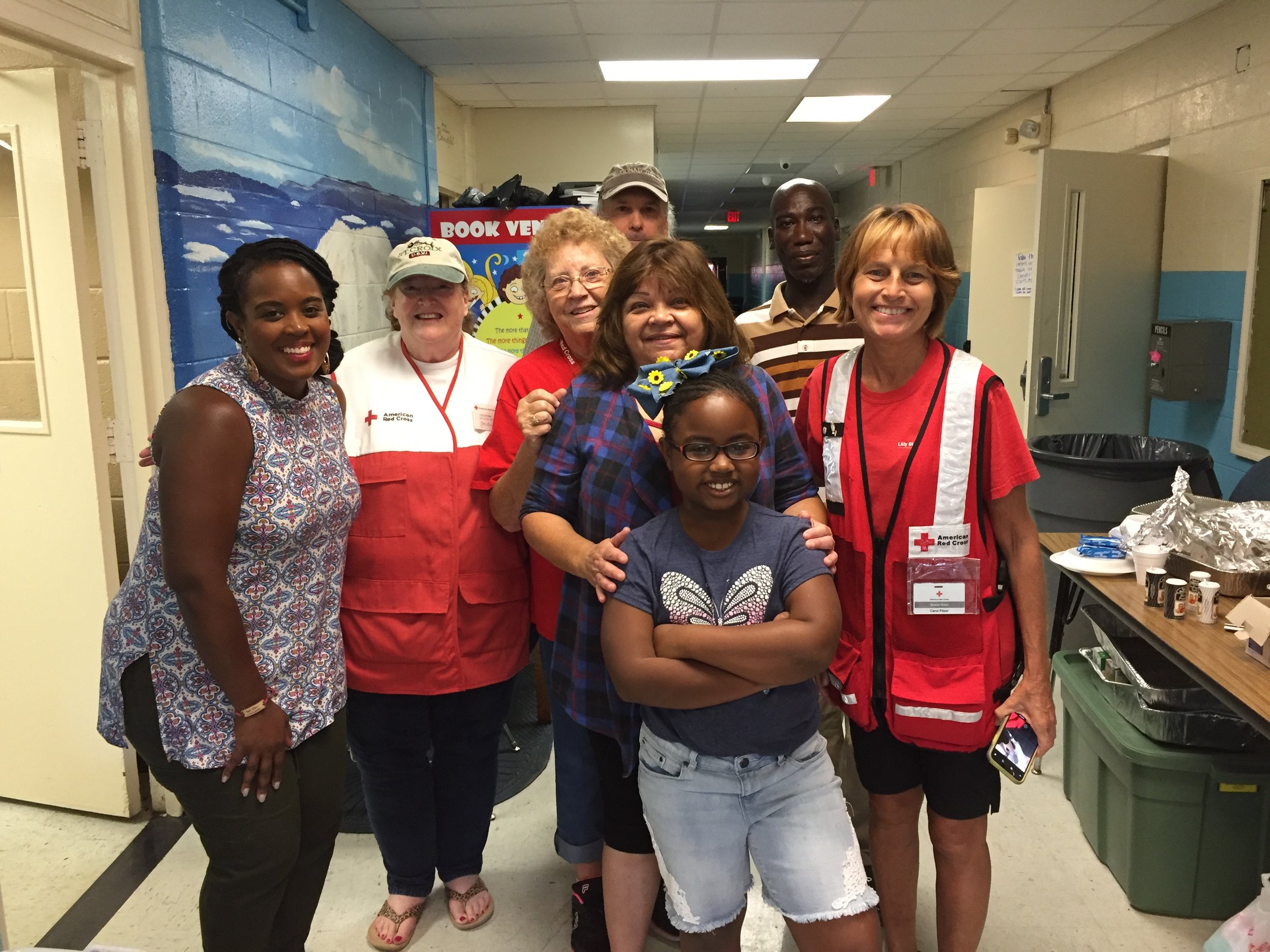  Carol Pitzer (front right) and Red Cross team members pause for a photo with community members who brought breakfast to clients in a North Carolina shelter during Hurricane Florence. (Photo courtesy of Carol Pitzer) 
