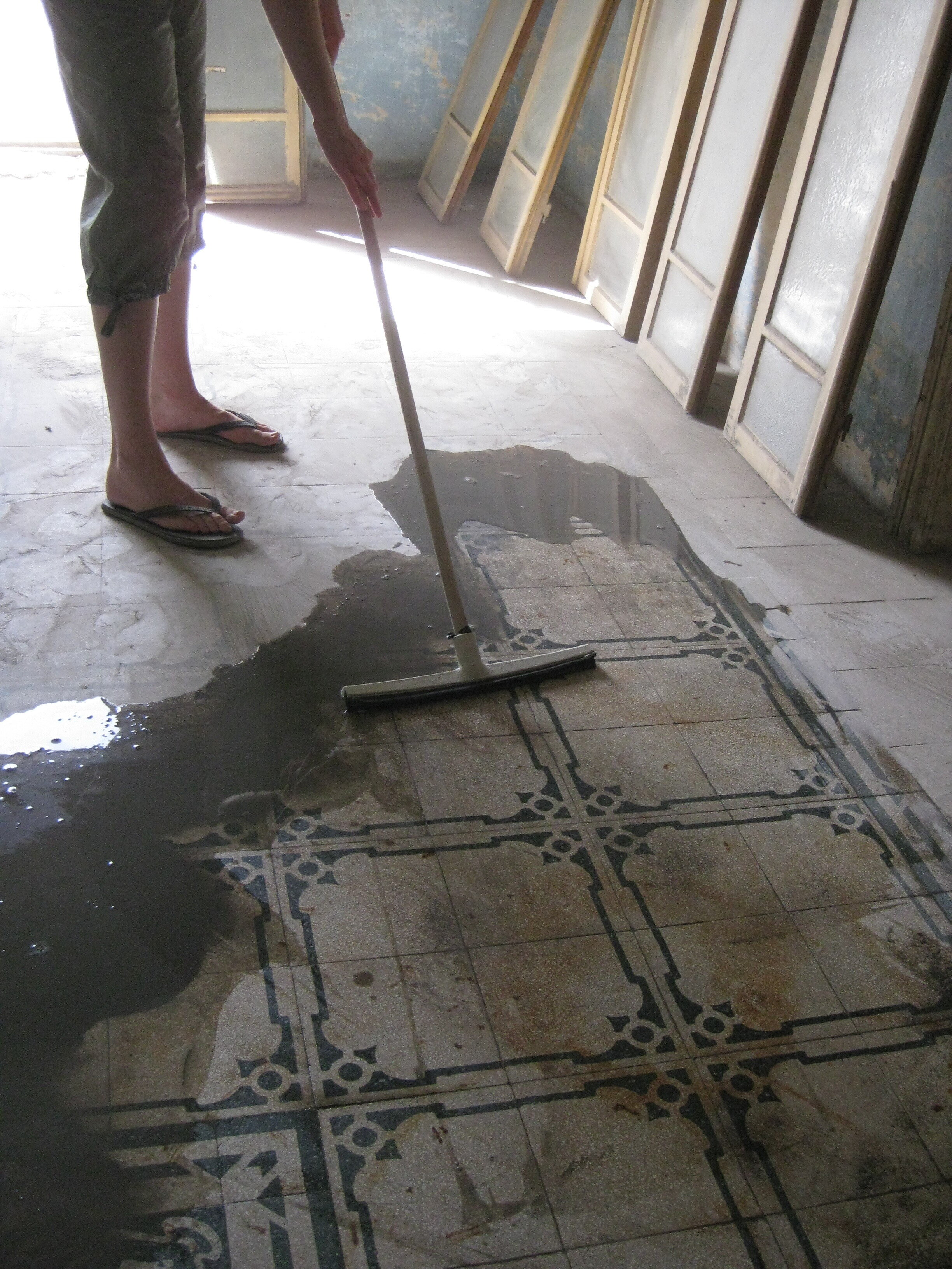 Uncovering original floor tiles under decades of dust