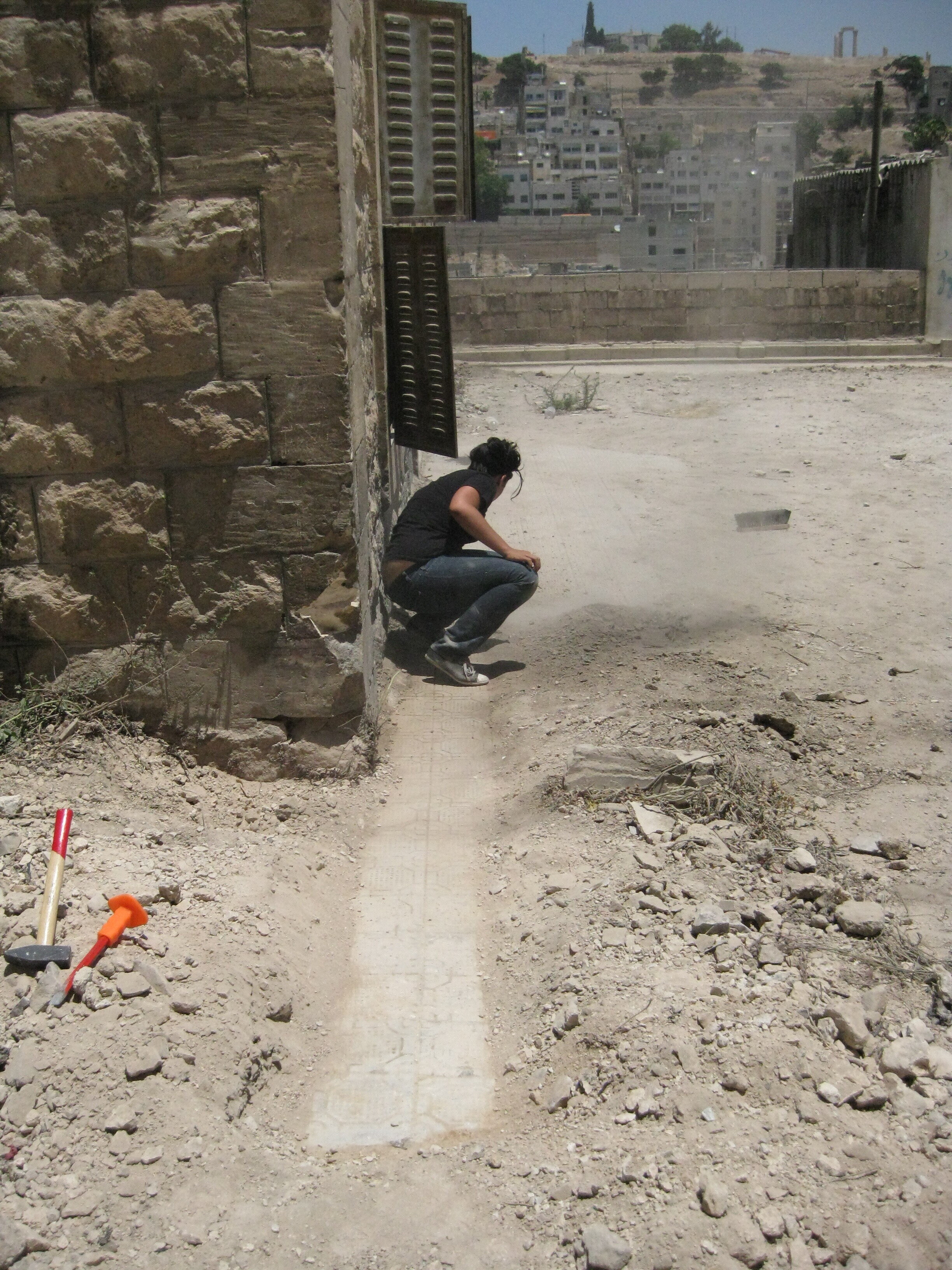 Uncovering original exterior tiles from what was the front garden and diwan, which had been used as a parking lot for decades