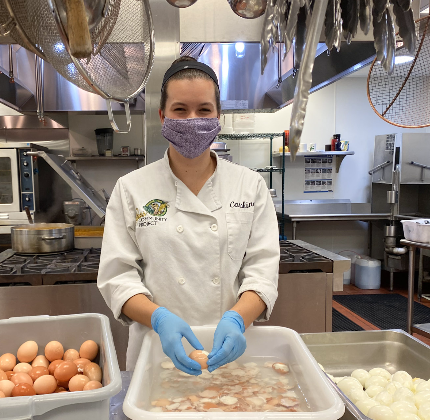 Ceres kitchen volunteer peeling hard boiled eggs.