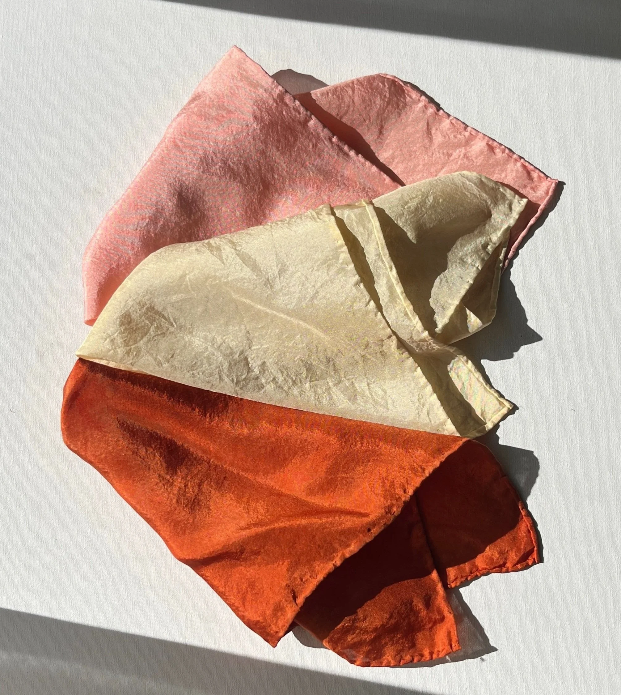 Colorful fabric squares in pink, beige, and orange