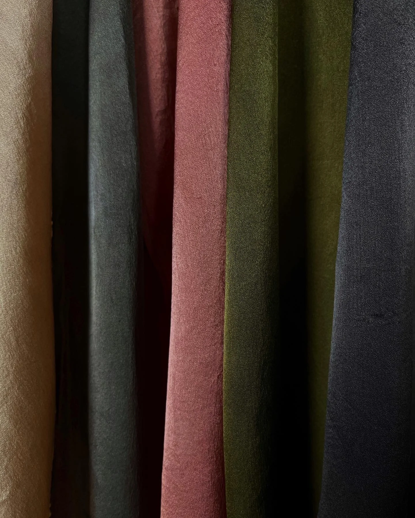 Various colored silk swatches hanging vertically