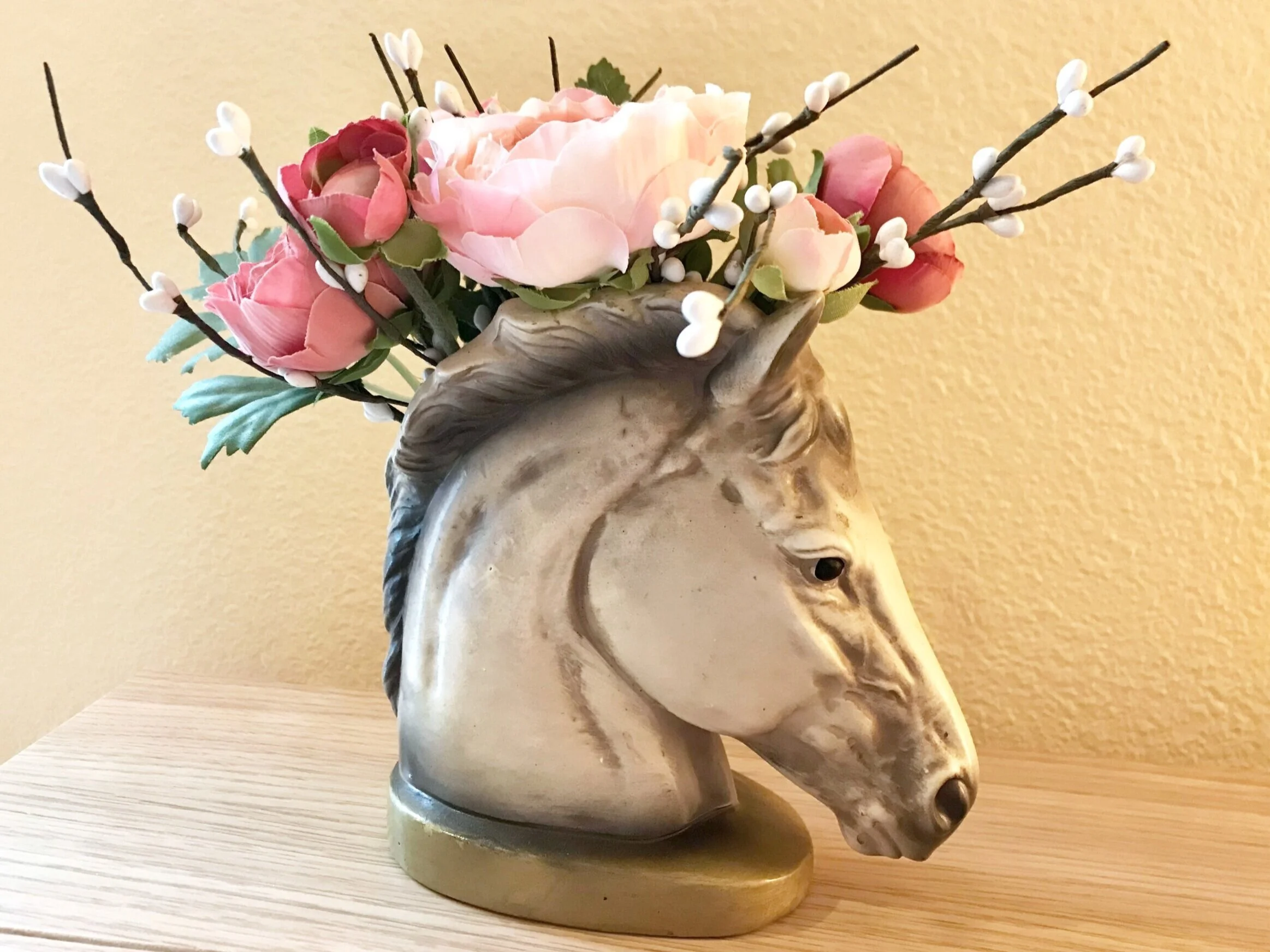 gray horse head vase with pink roses