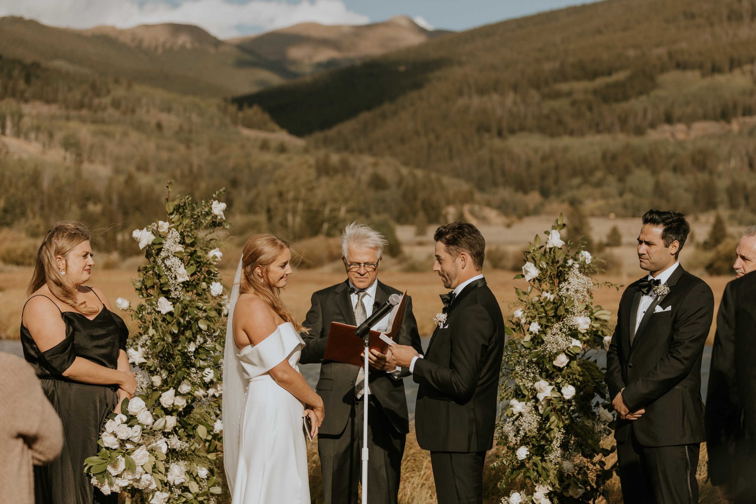 bride and groom exchanging vows at Emmy & Dick's Chic, Sophisticated Black-Tie Vail Wedding