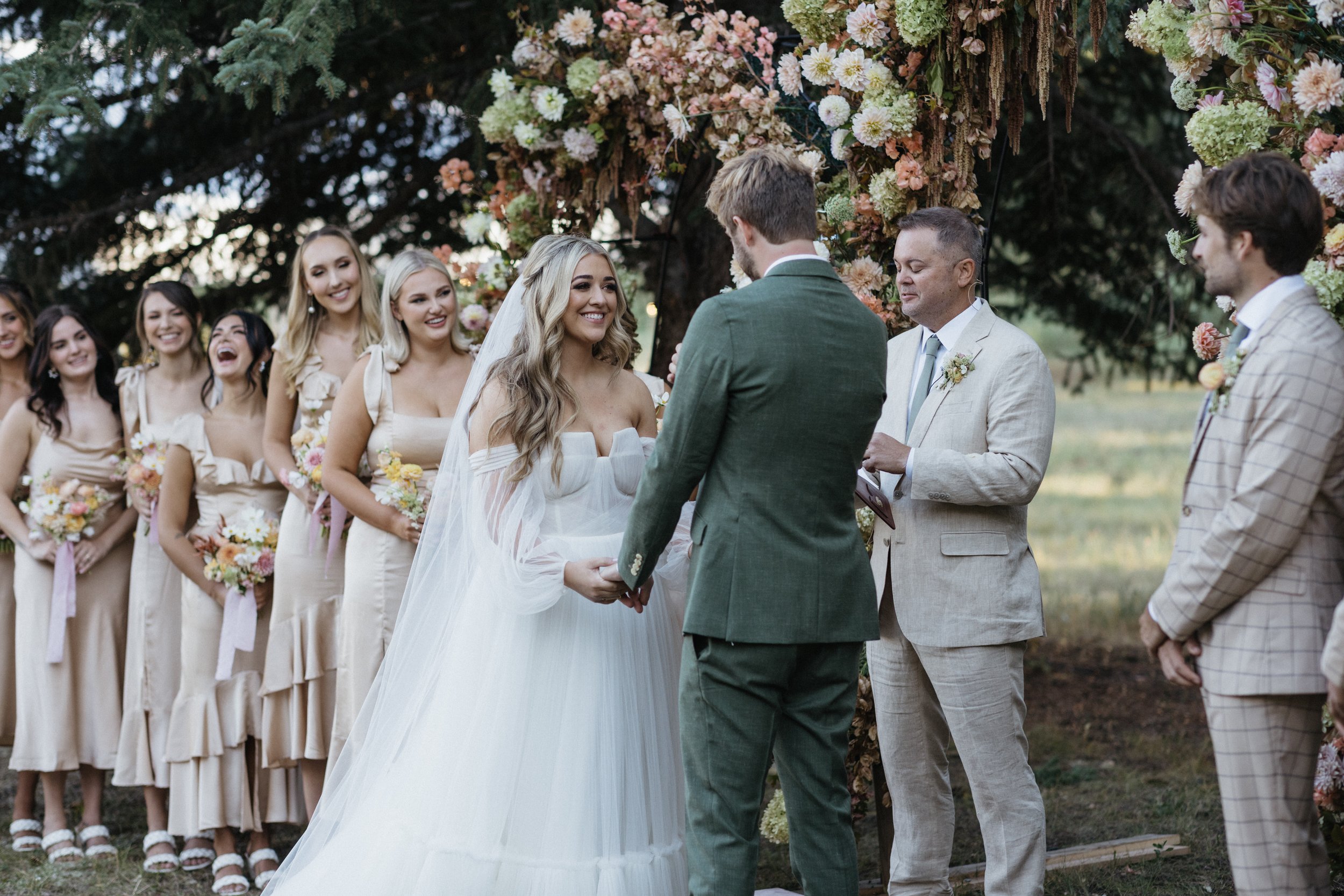 bride and groom saying their vows at their wedding ceremony of their wedding with a colorful wedding palette