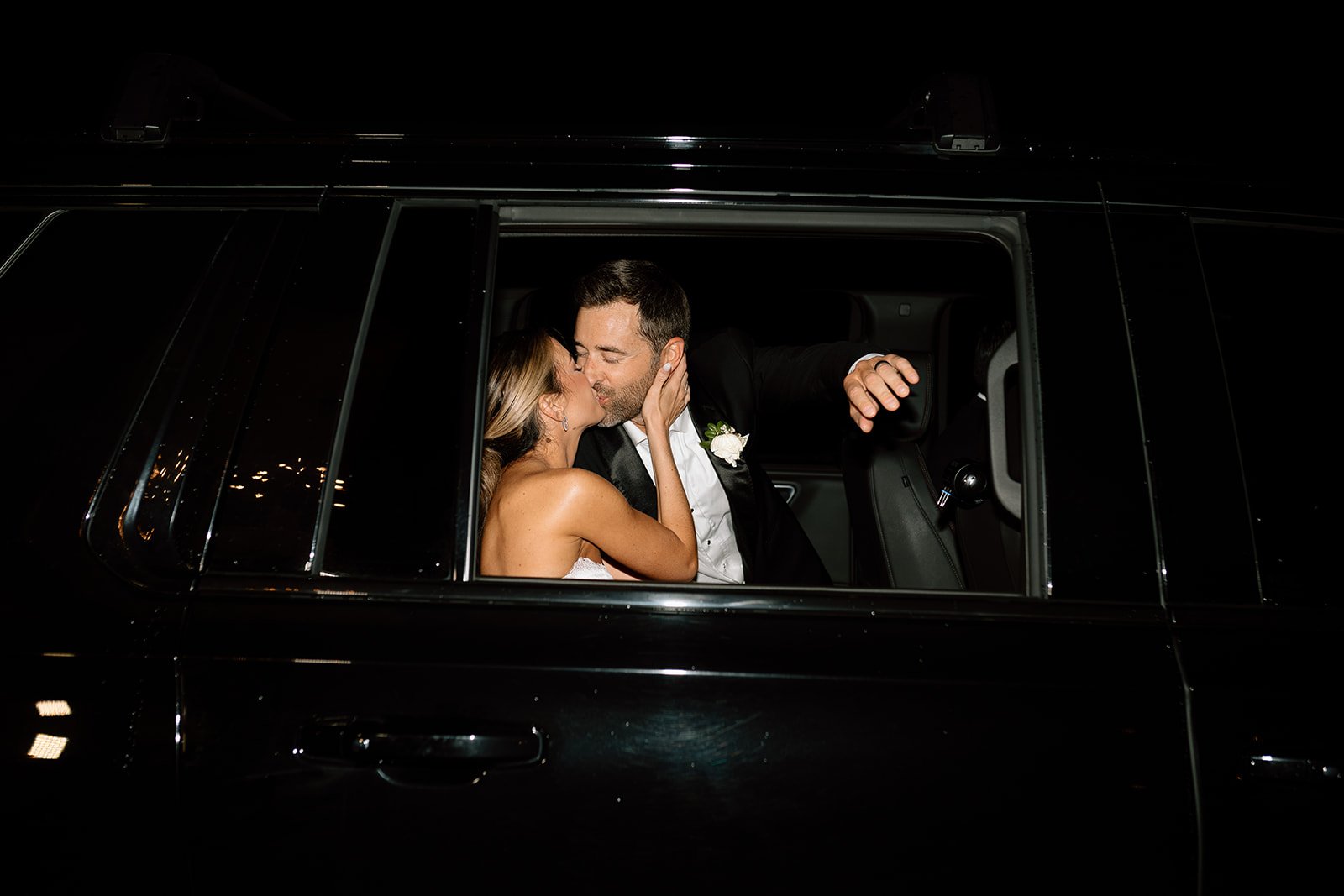 bride anf groom in the getaway car at Crystal & Derek's Elegant Destination Wedding in Colorado at The Manor House