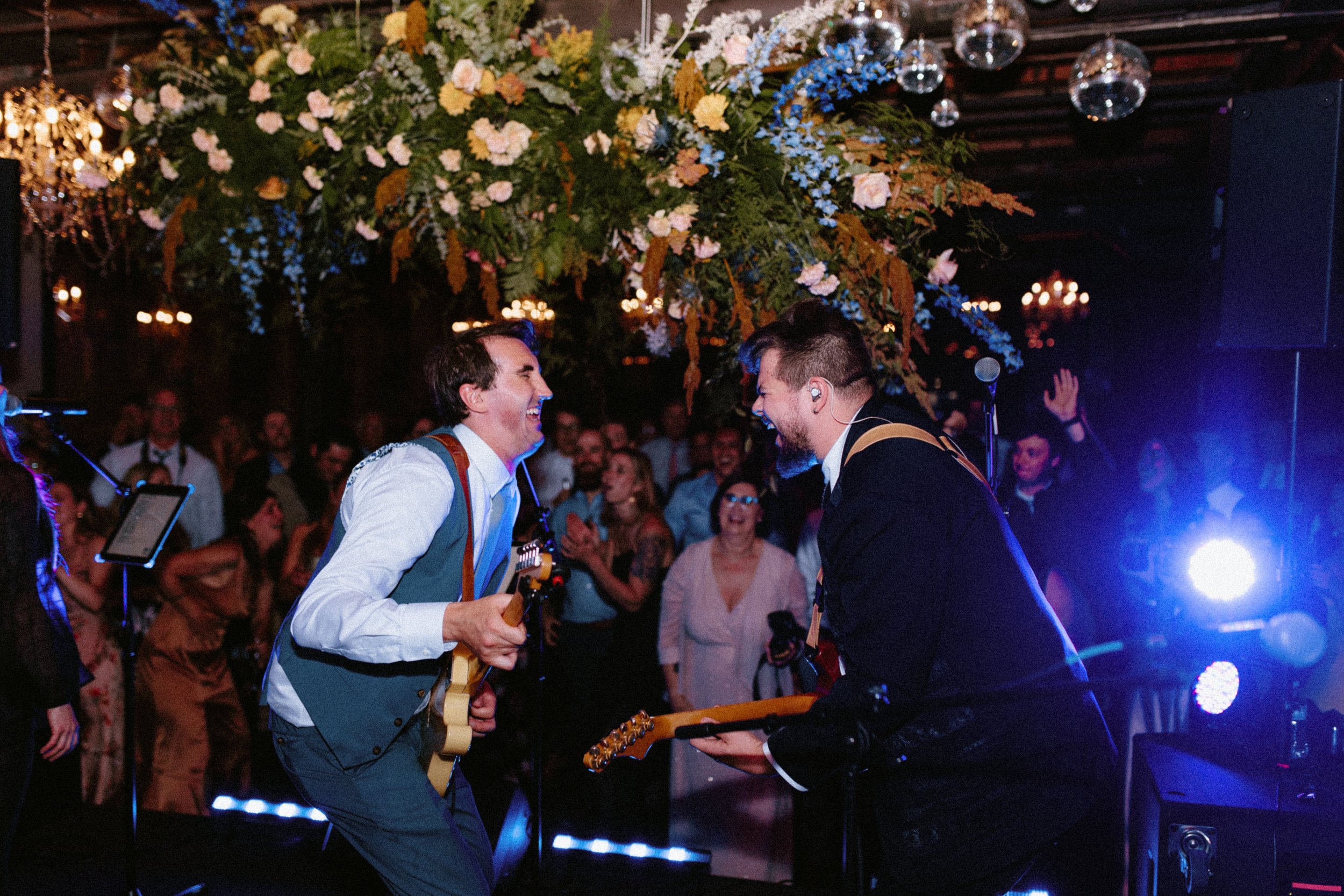 groom playing guitar at his wedding, a lovely wedding reception idea
