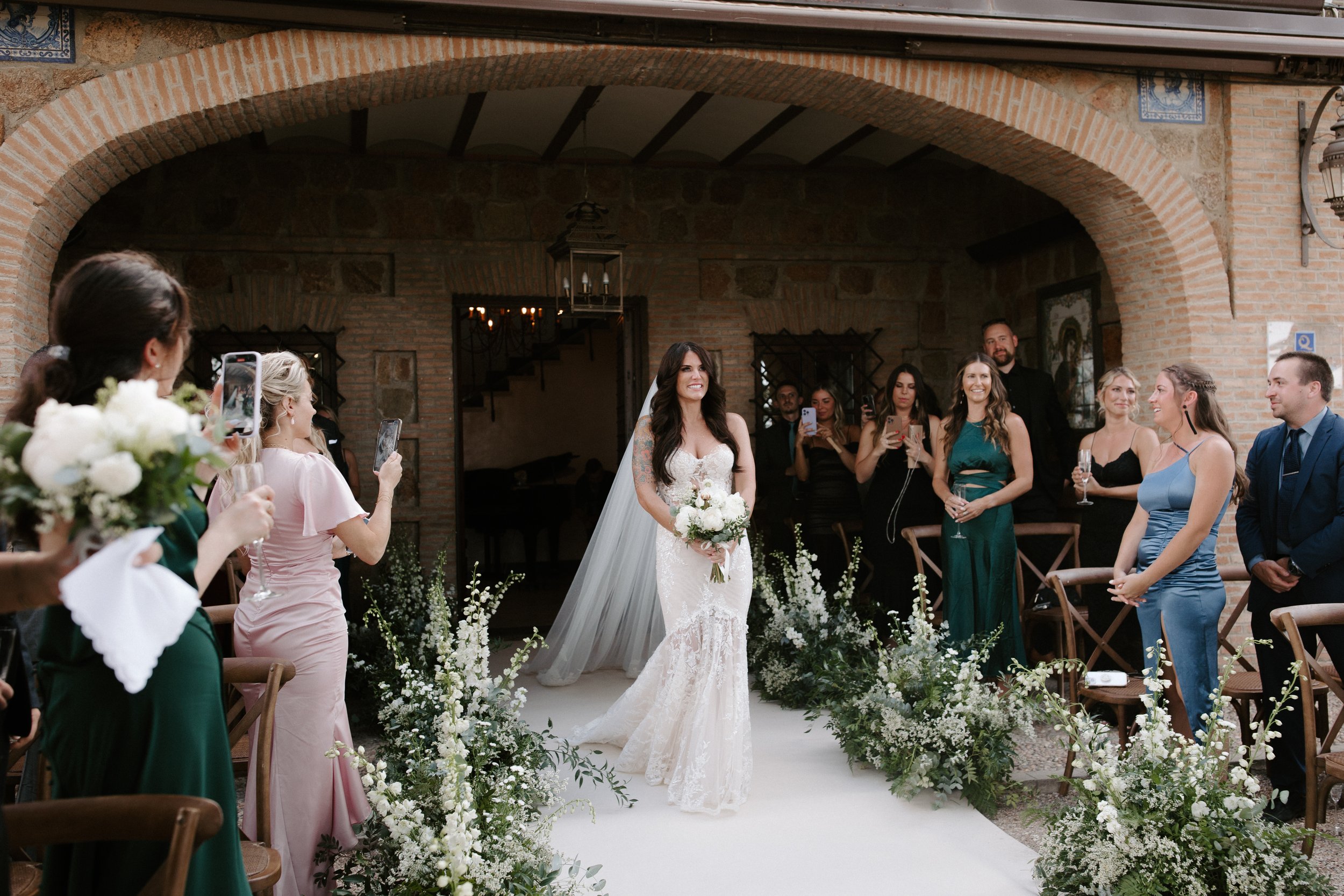 bride walking down the aisle at one of her gorgeous spanish wedding venues