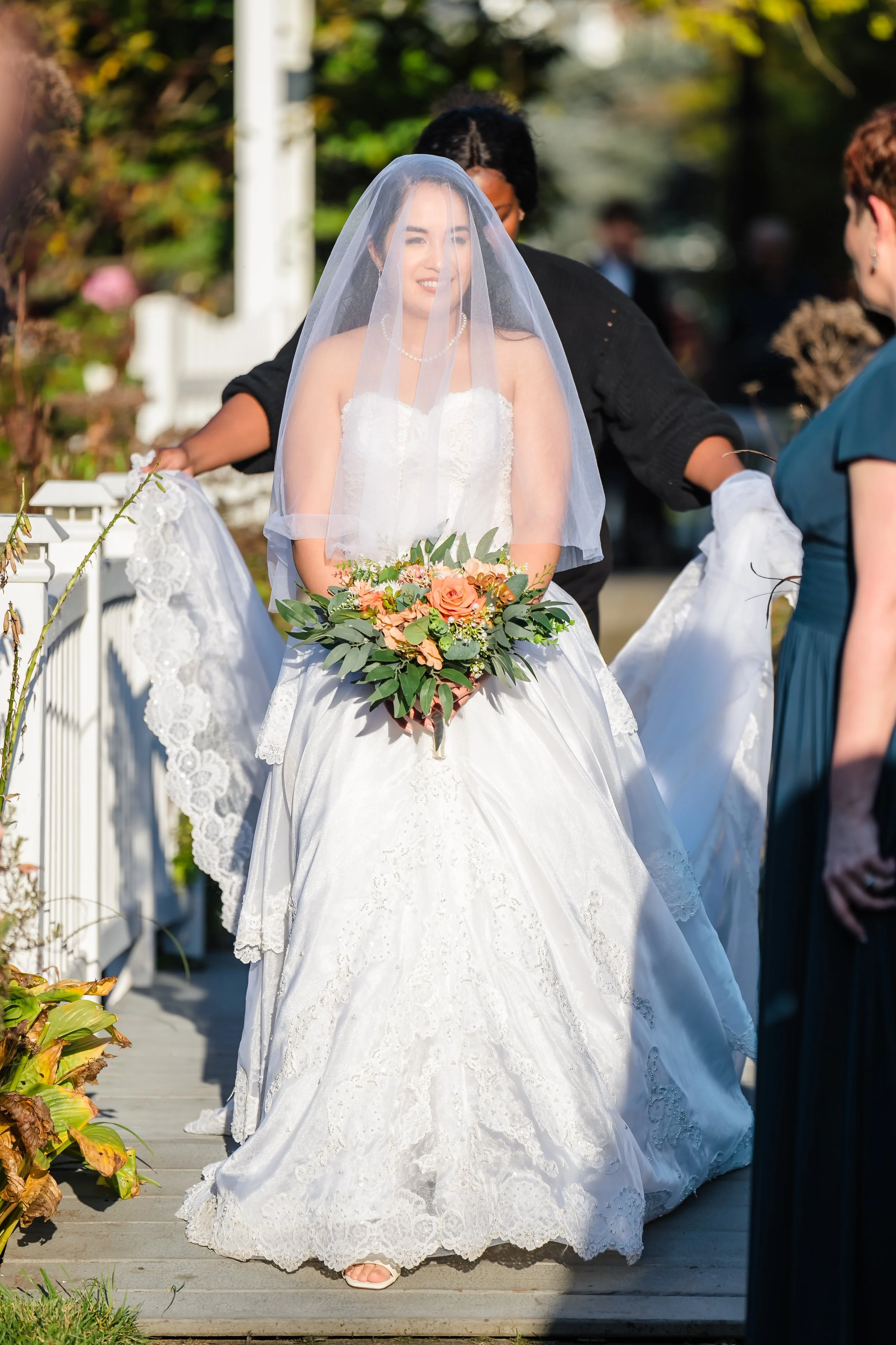 Bride walks down the aisle on her wedding at the Queens Botanical Gardens