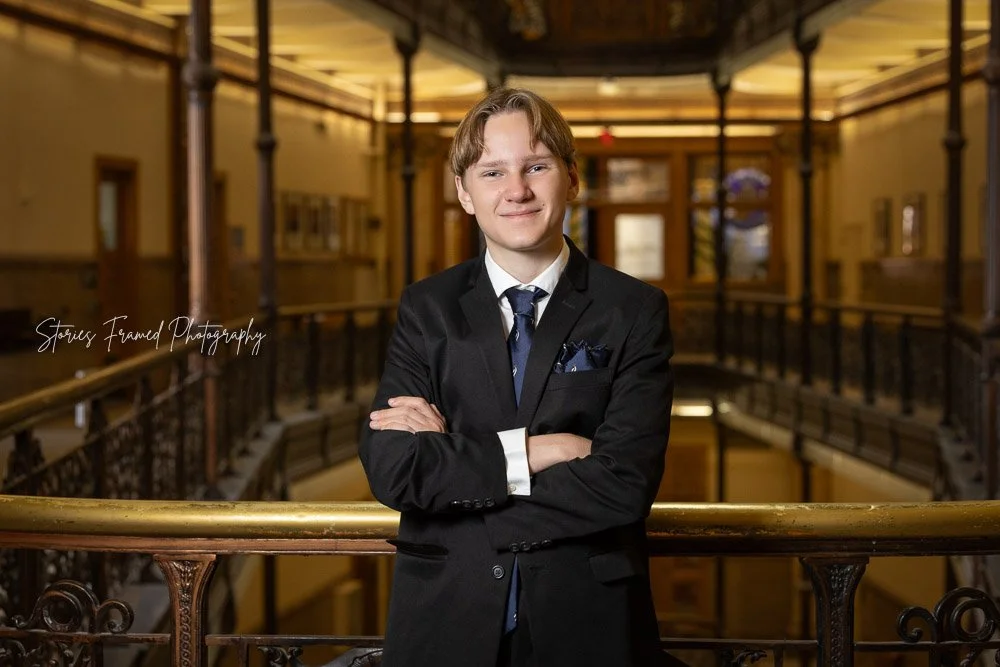 senior boy posed confidently in Milwaukee City Hall