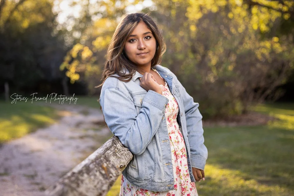 Brookfield Central Class of 2027 senior portrait of Seher in a floral dress and denim jacket at golden hour in a Brookfield WI park