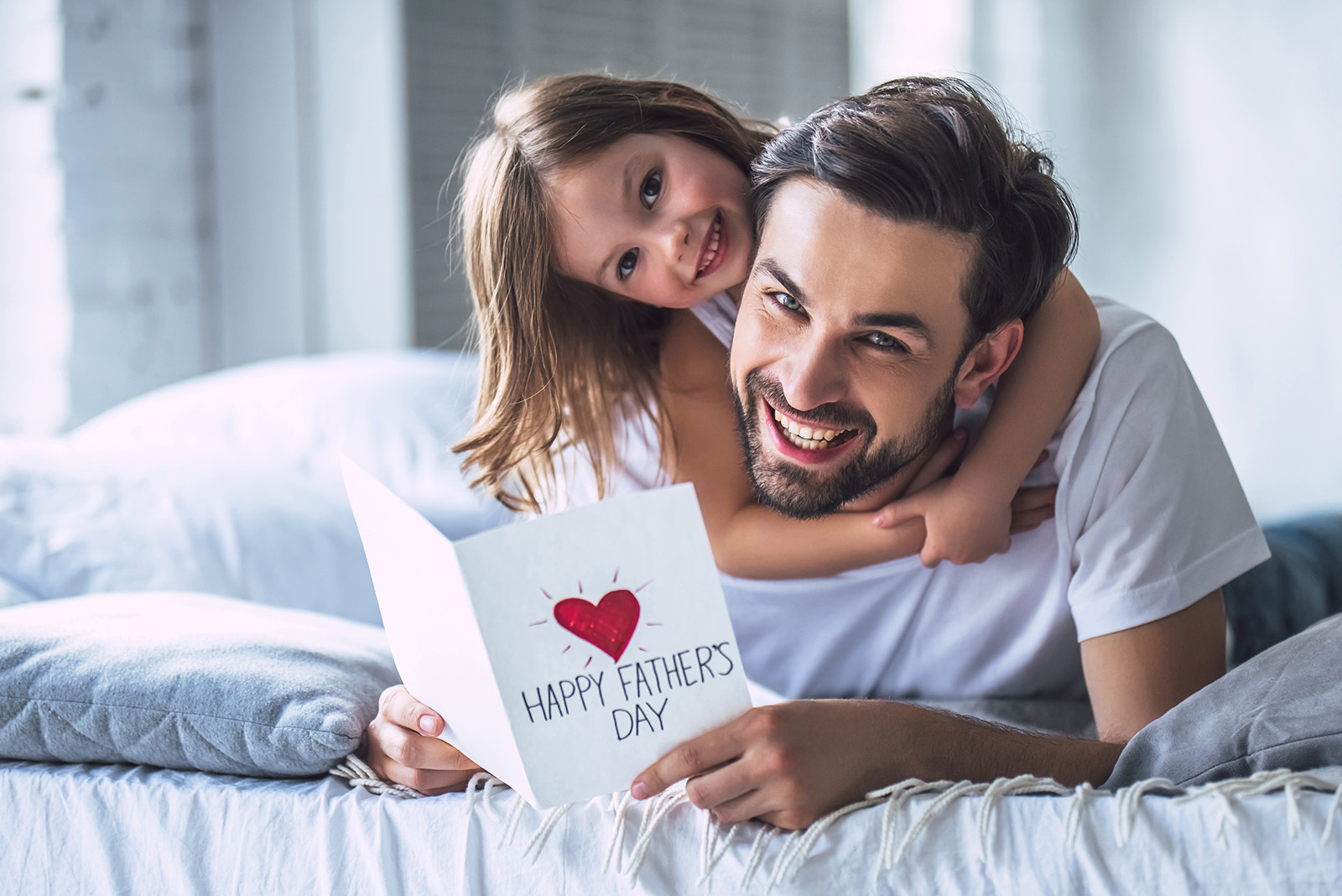 Padre e hija leyendo tarjeta de el dia de los padres