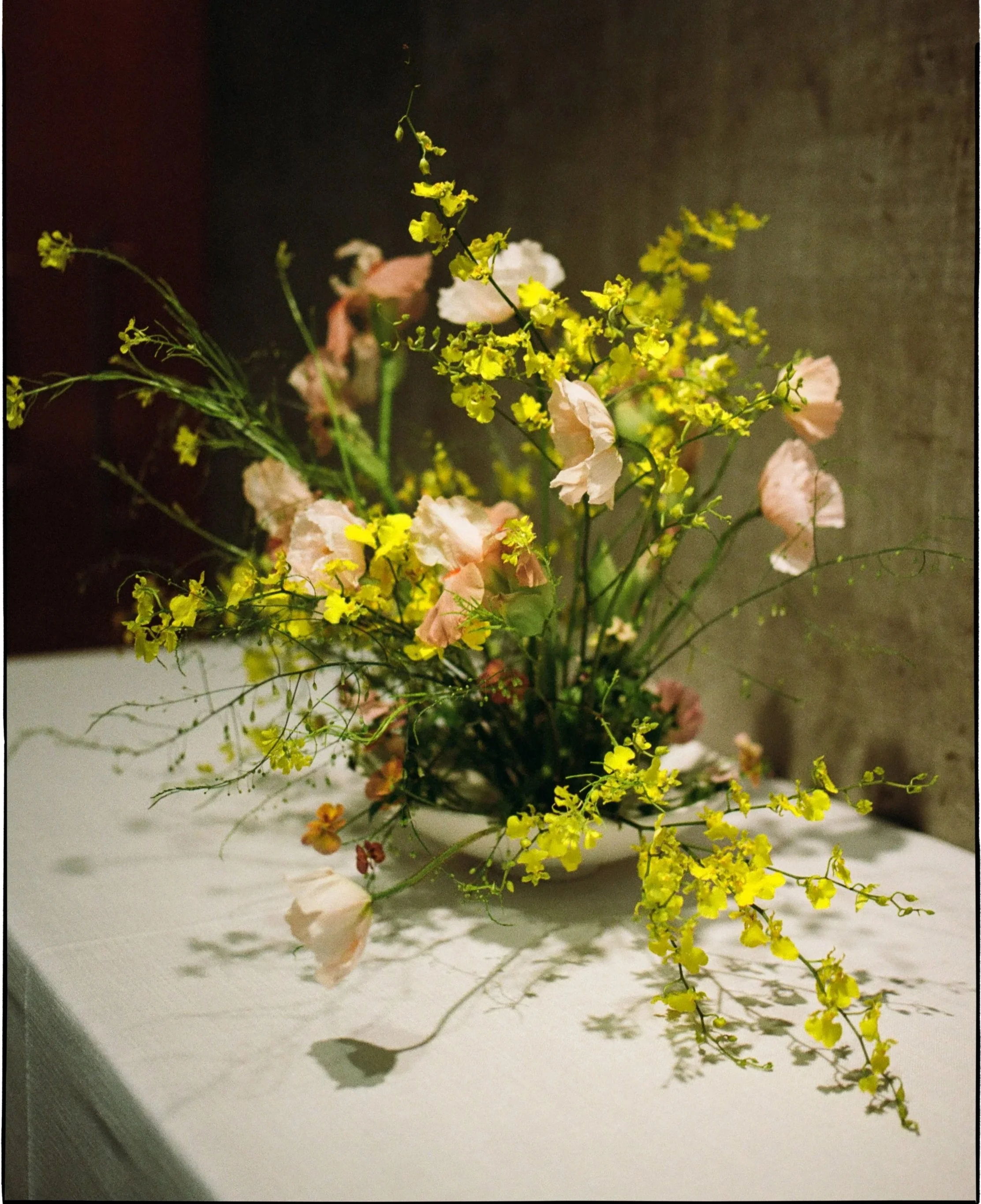 A photo of a yellow and peach wedding tablescape