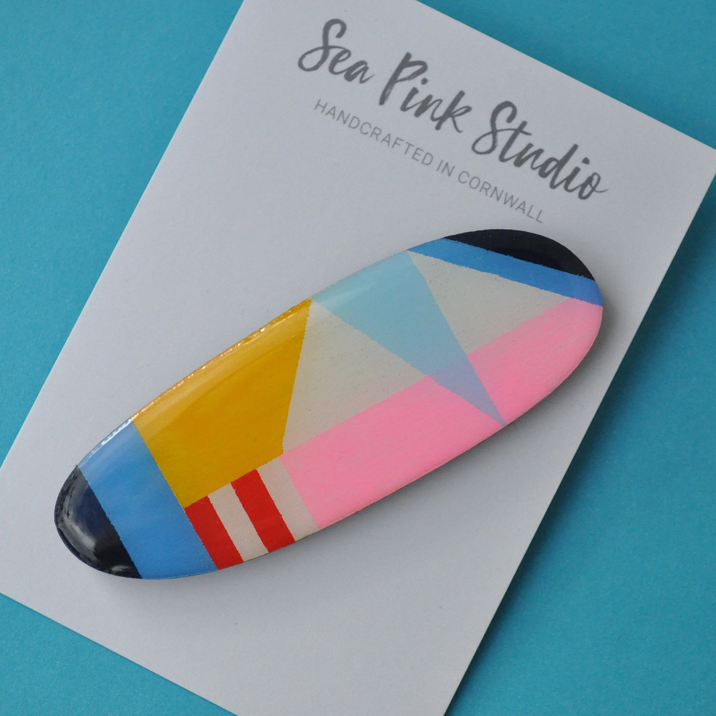 Colourful wooden hair slide in geometric pattern