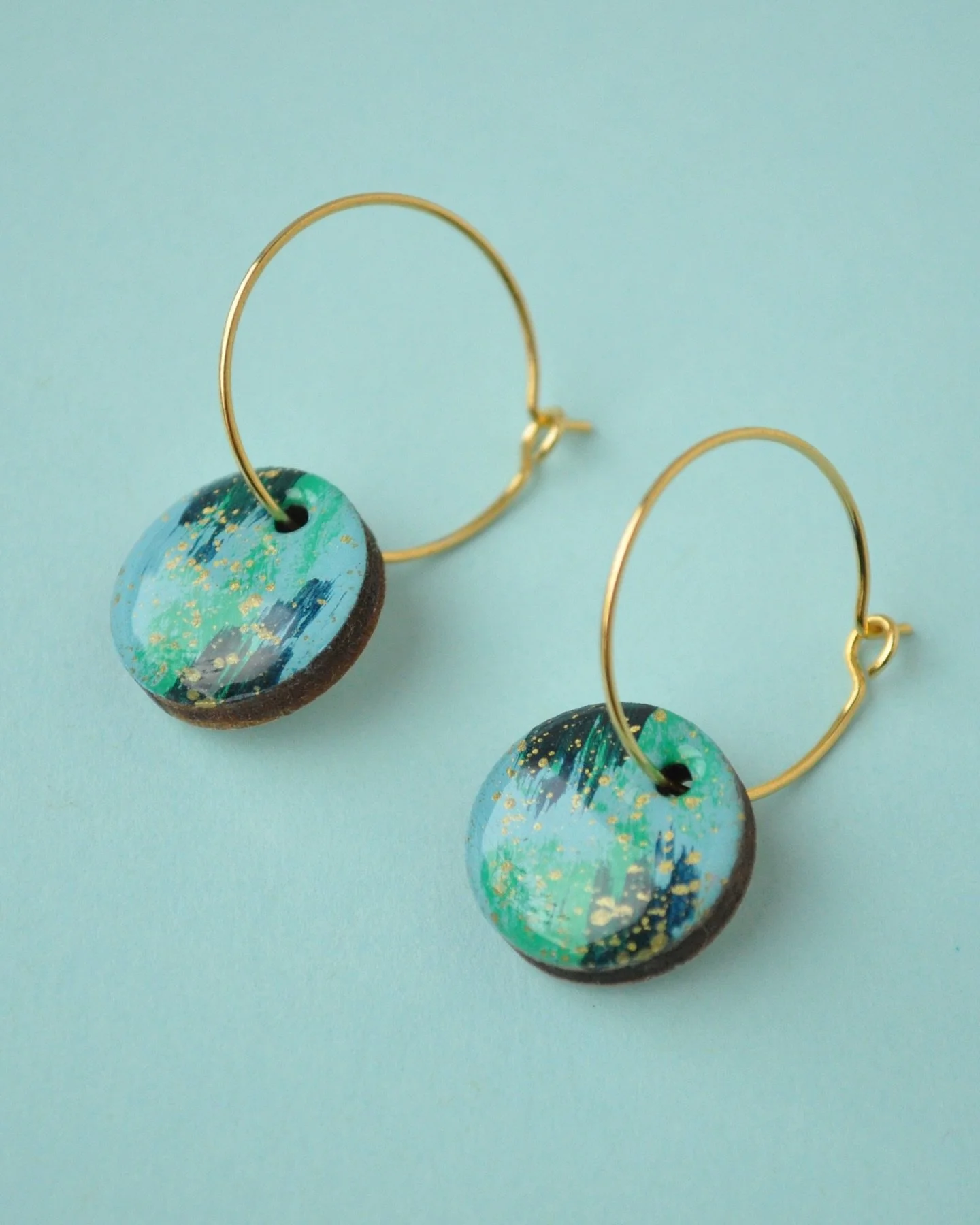 Slowly but surely, new pieces are emerging including these pretty green and turquoise earrings inspired by the colours of water and seaweeds. Painted in a loose brush style with little flecks of gold to capture the impression of sunshine on water the