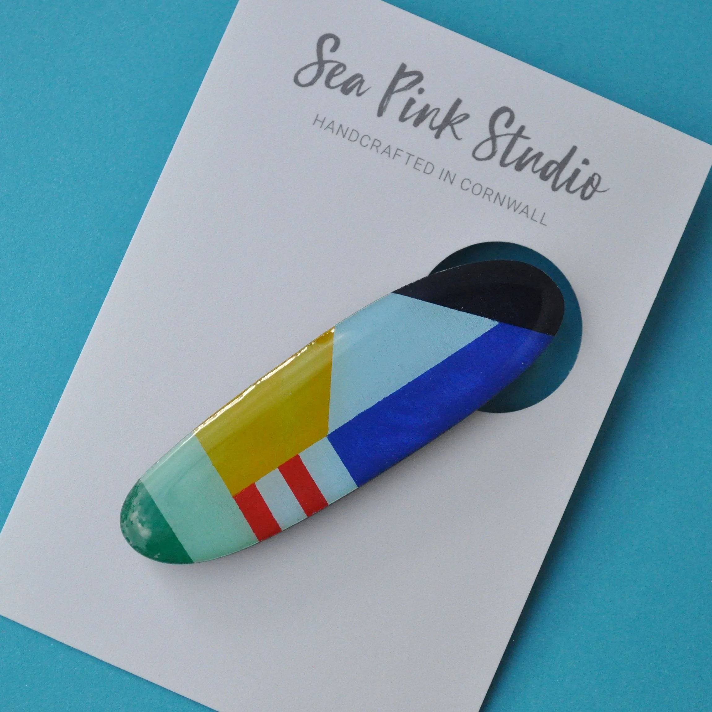 Colourful wooden hair slide in geometric pattern