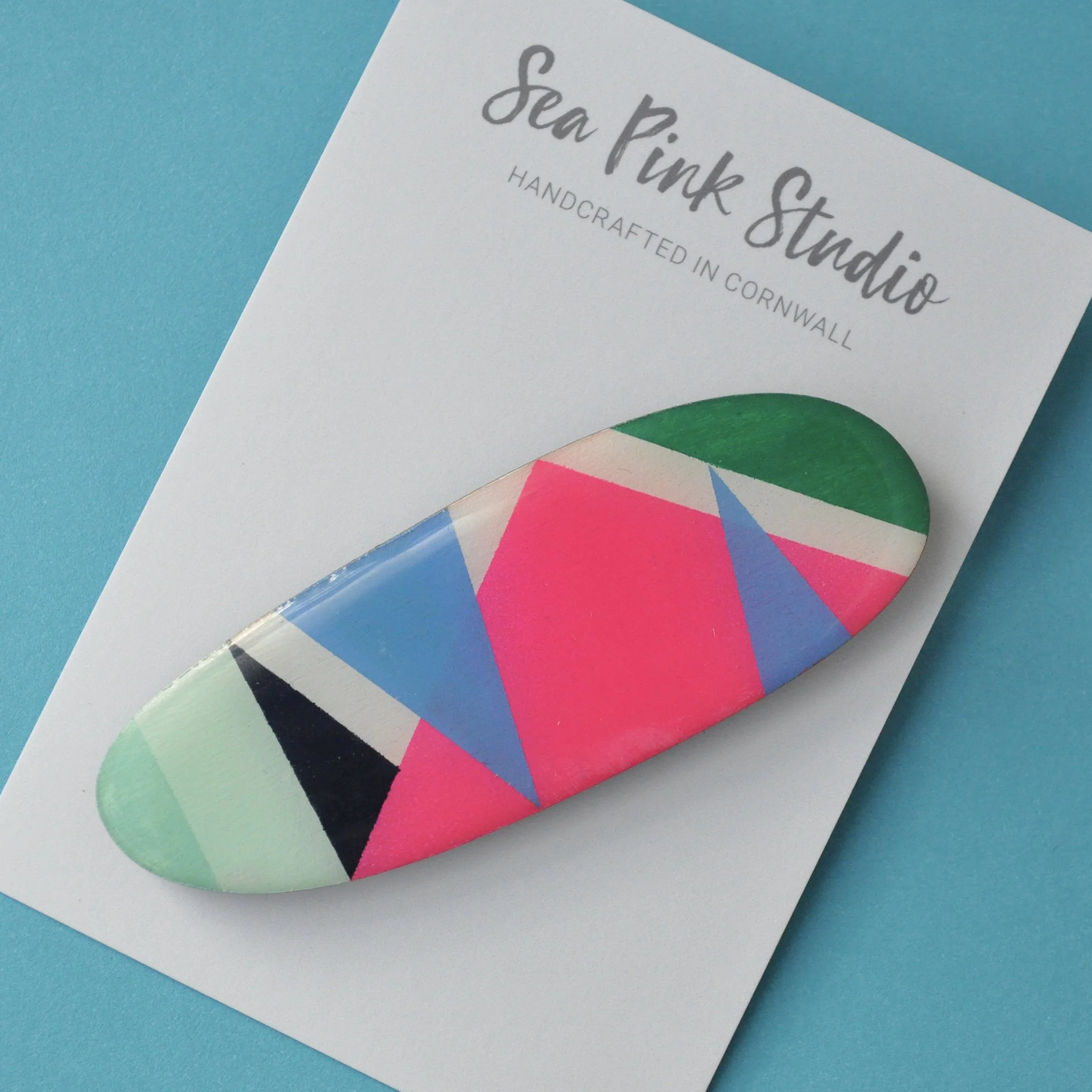 Colourful wooden hair slide in geometric pattern