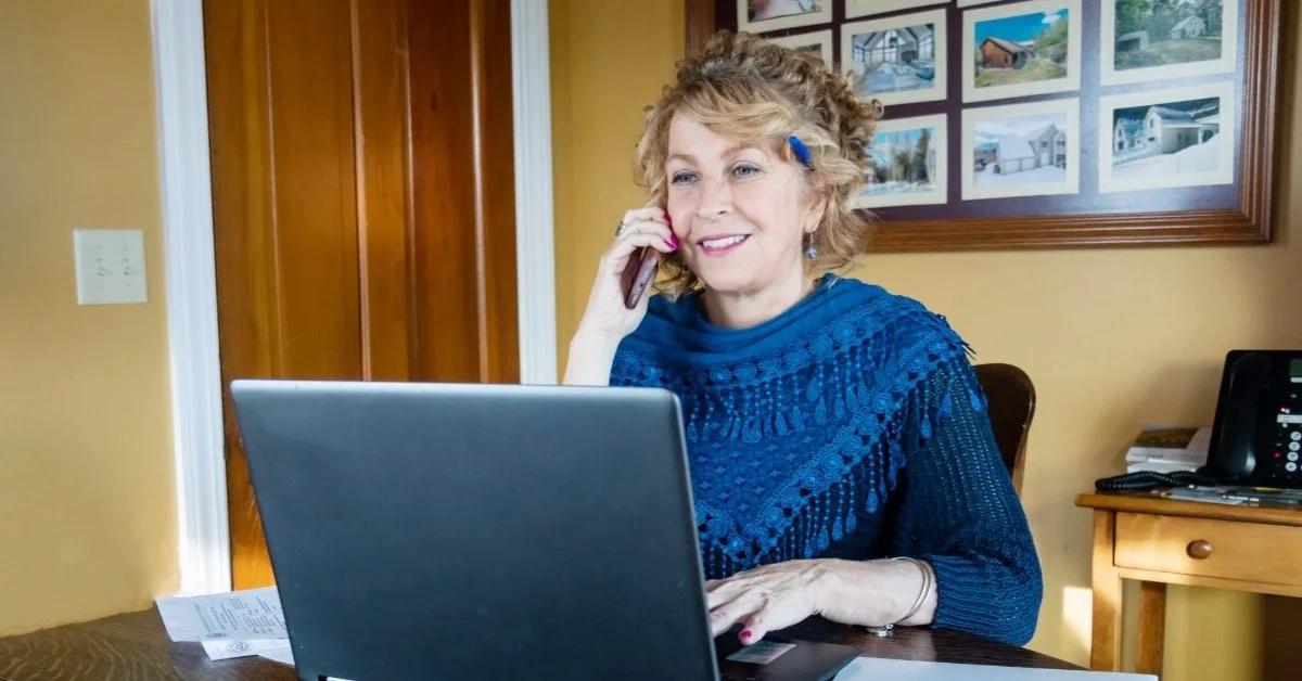 Lisa Brouillette, REALTOR® with The Valley Realty, working with a home buyer by phone from her North Conway office in the Mount Washington Valley