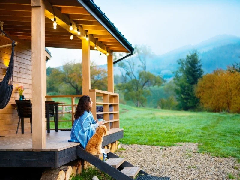 Mountain home in Carroll County, New Hampshire, with a covered porch overlooking wooded hills.