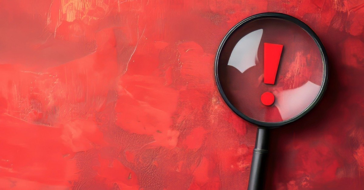 A magnifying glass over a red exclamation point, representing the warning signs and red flags to watch for when evaluating a condo HOA in Mt. Washington Valley