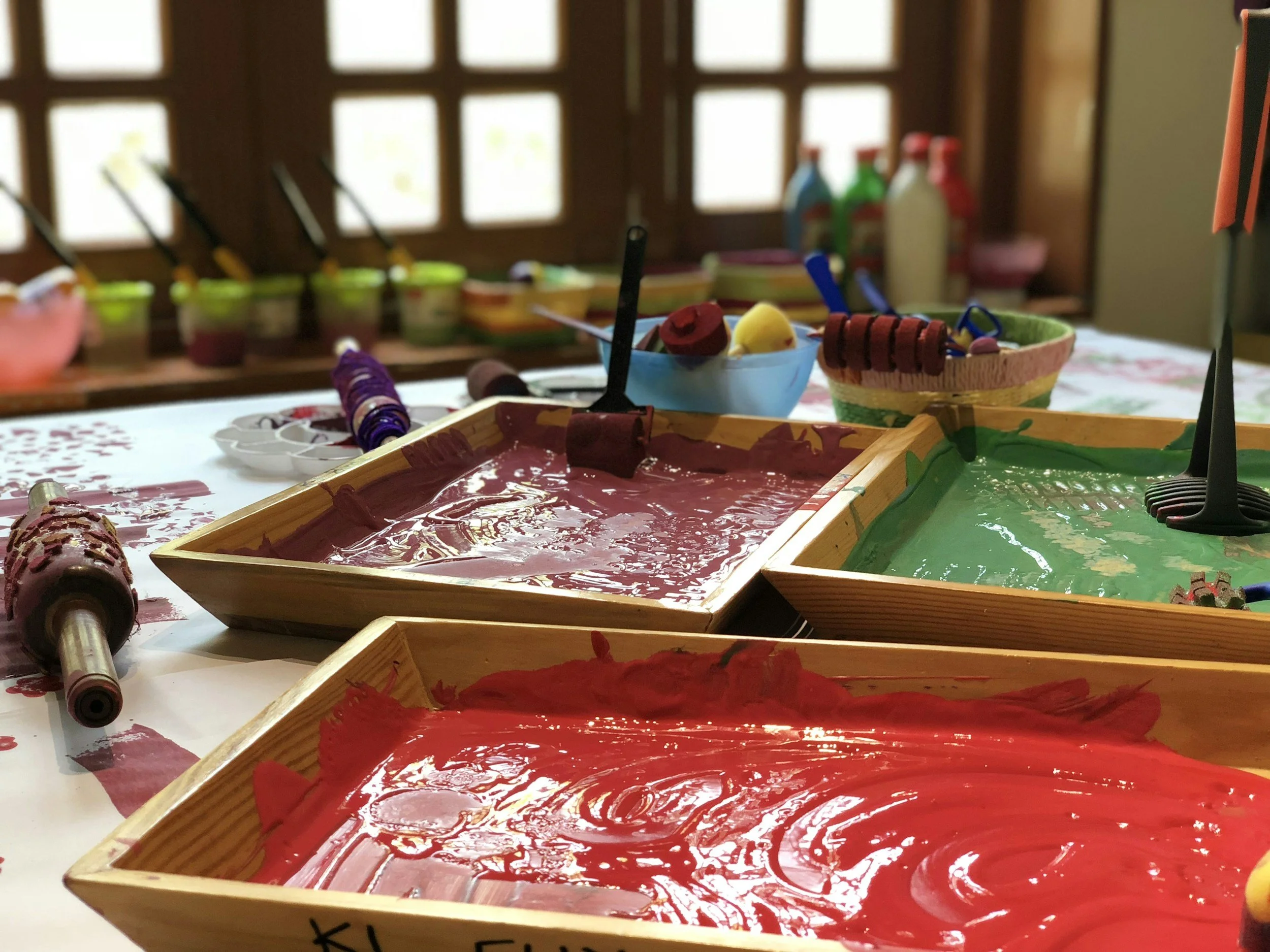 Trays of paint on table at Teton Arts