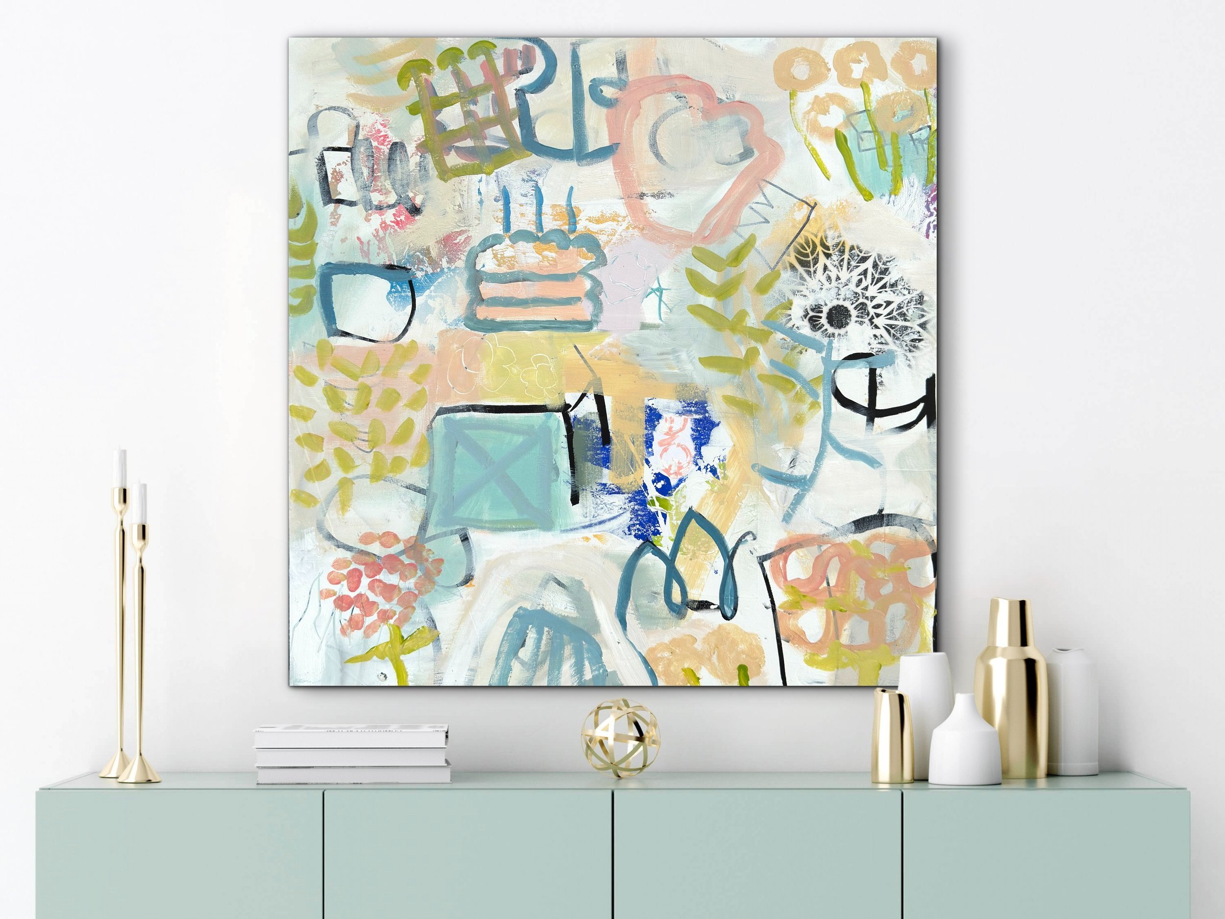 Just the Candles by Elizabeth Williams displayed above a pale green console table with gold and white decorative objects.