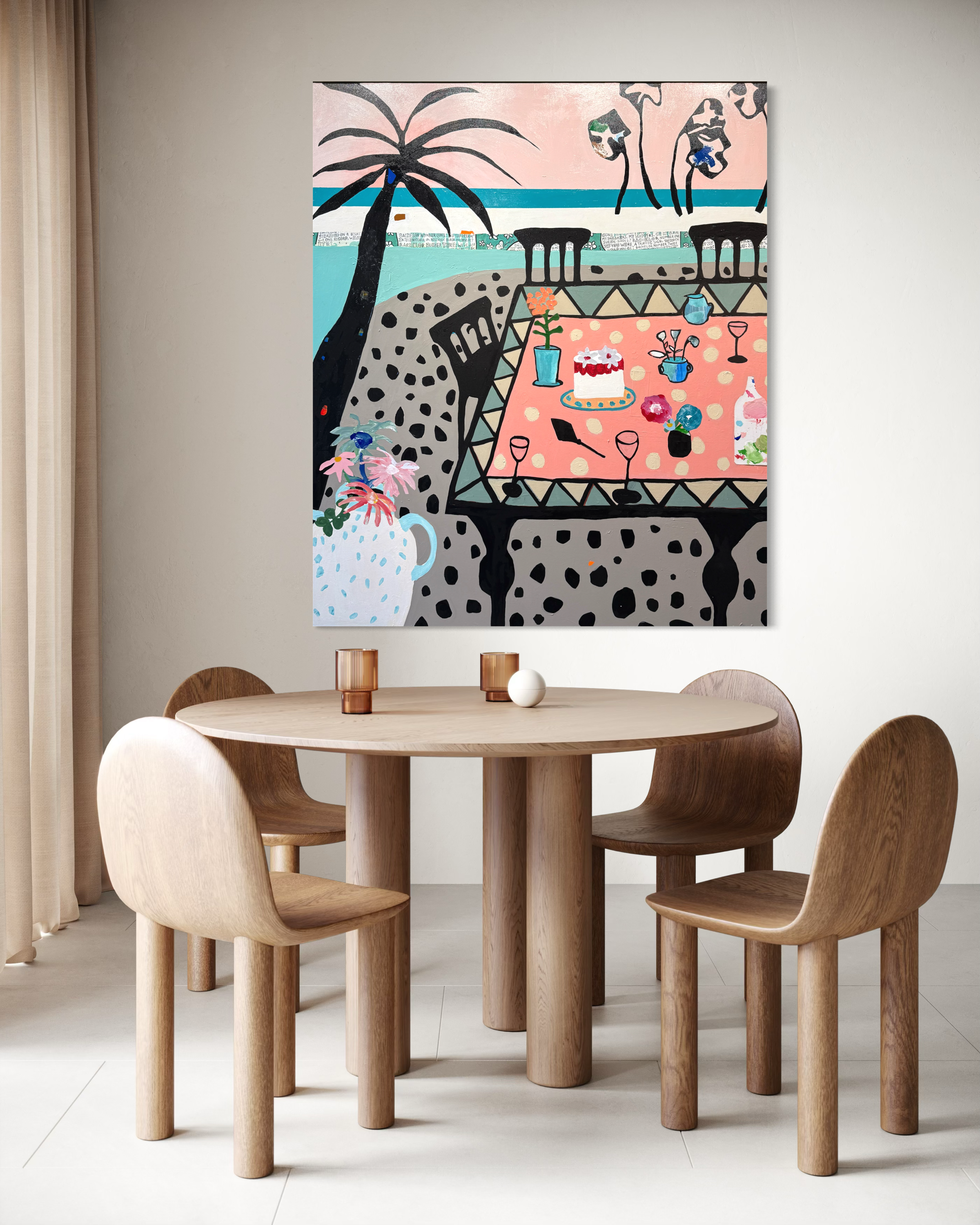 A round wooden dining table surrounded by five wooden chairs with curved backs in a minimalist dining room. On the table, there are three glasses, a white spherical decor piece, and a pink tablecloth with polka dots. A large abstract wall art depicti