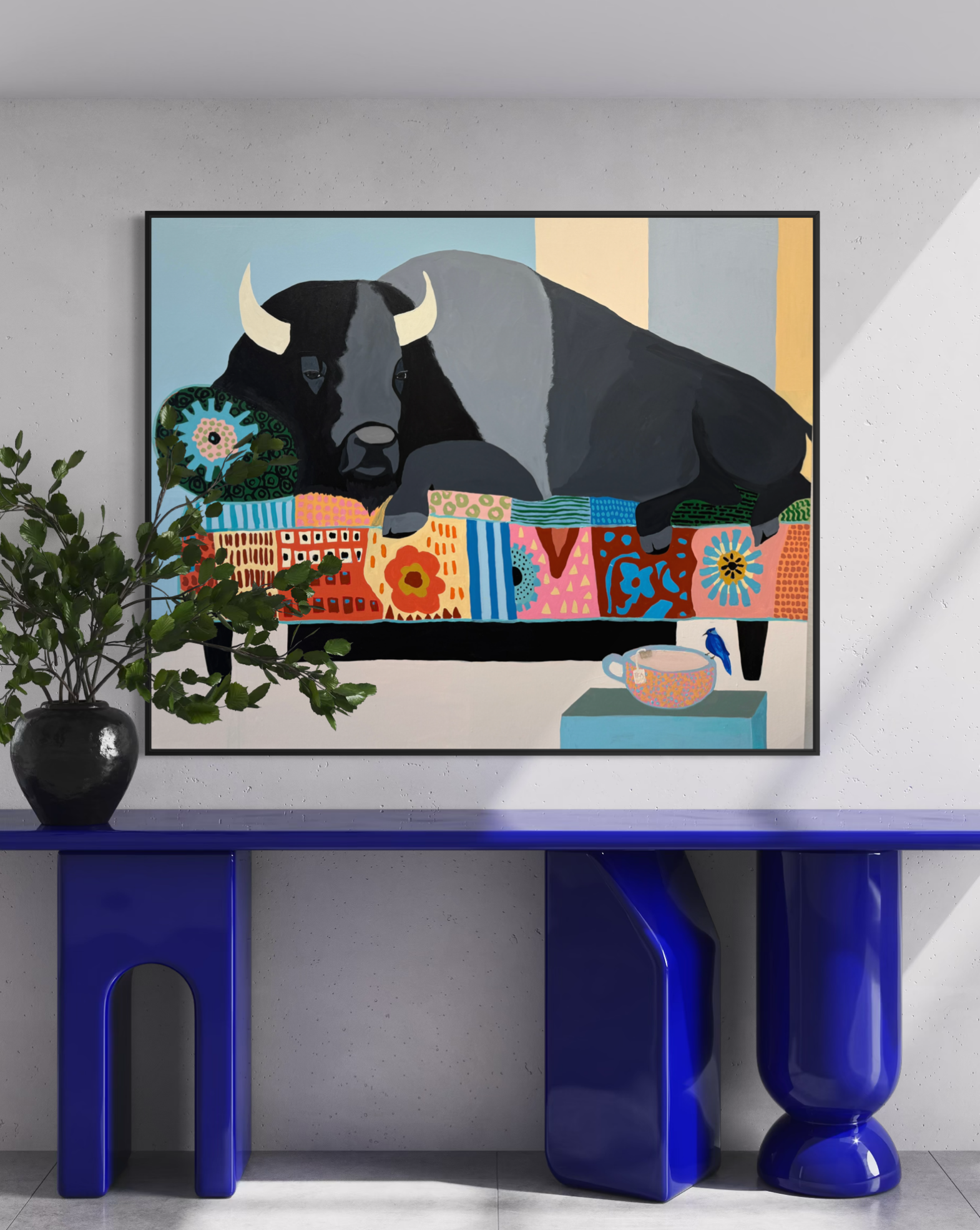 The Matter of Cold Tea displayed above a blue console table in a modern interior.