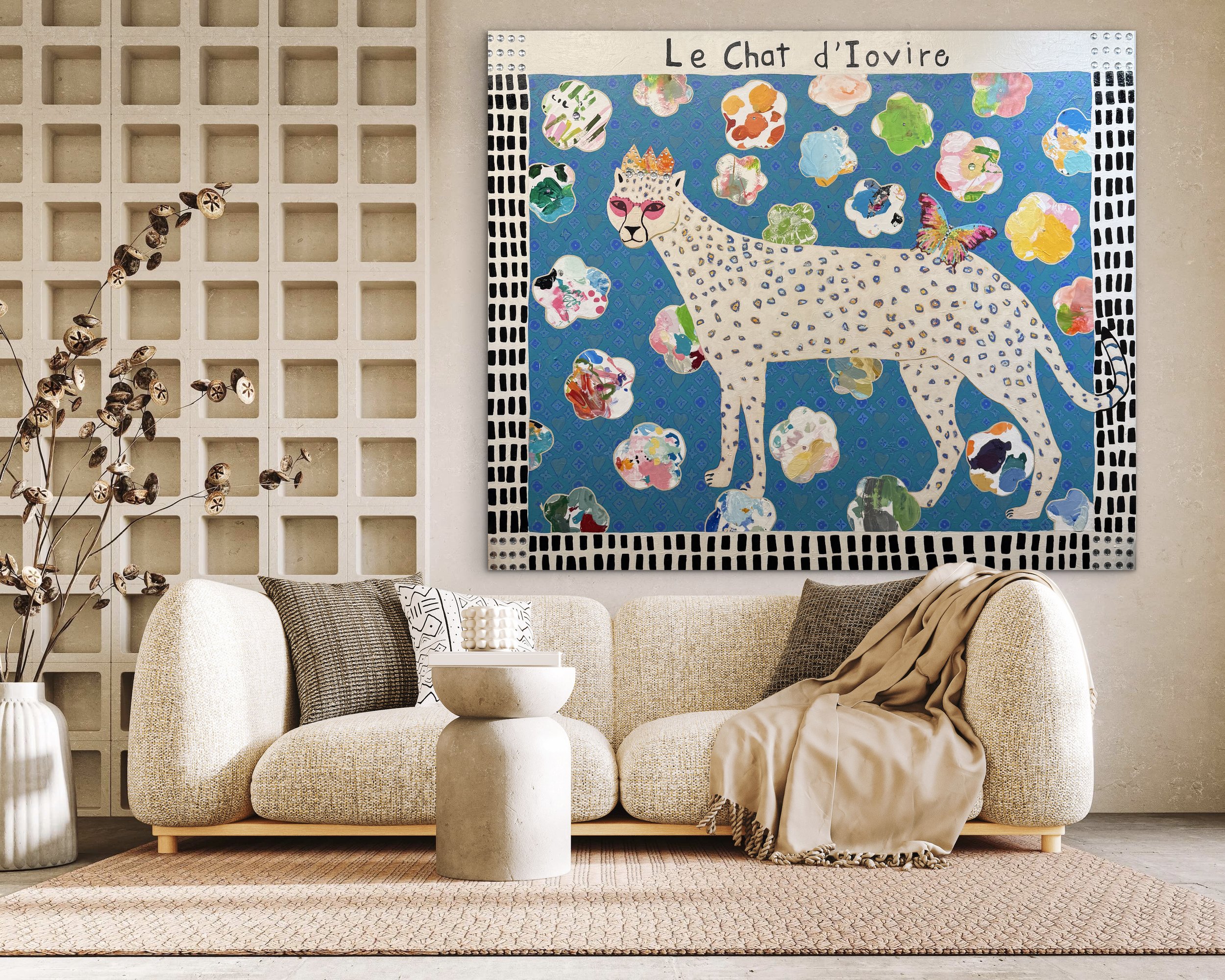 In-room mockup of Le Chat d’Ivoire, a 60x72 mixed media painting of a crowned white spotted cat on a blue patterned background with colorful shapes and a butterfly.