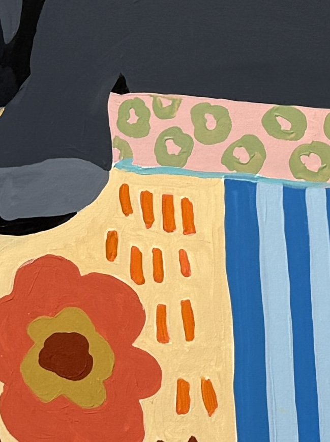 Detail of the colorful patterned sofa in The Matter of Cold Tea.