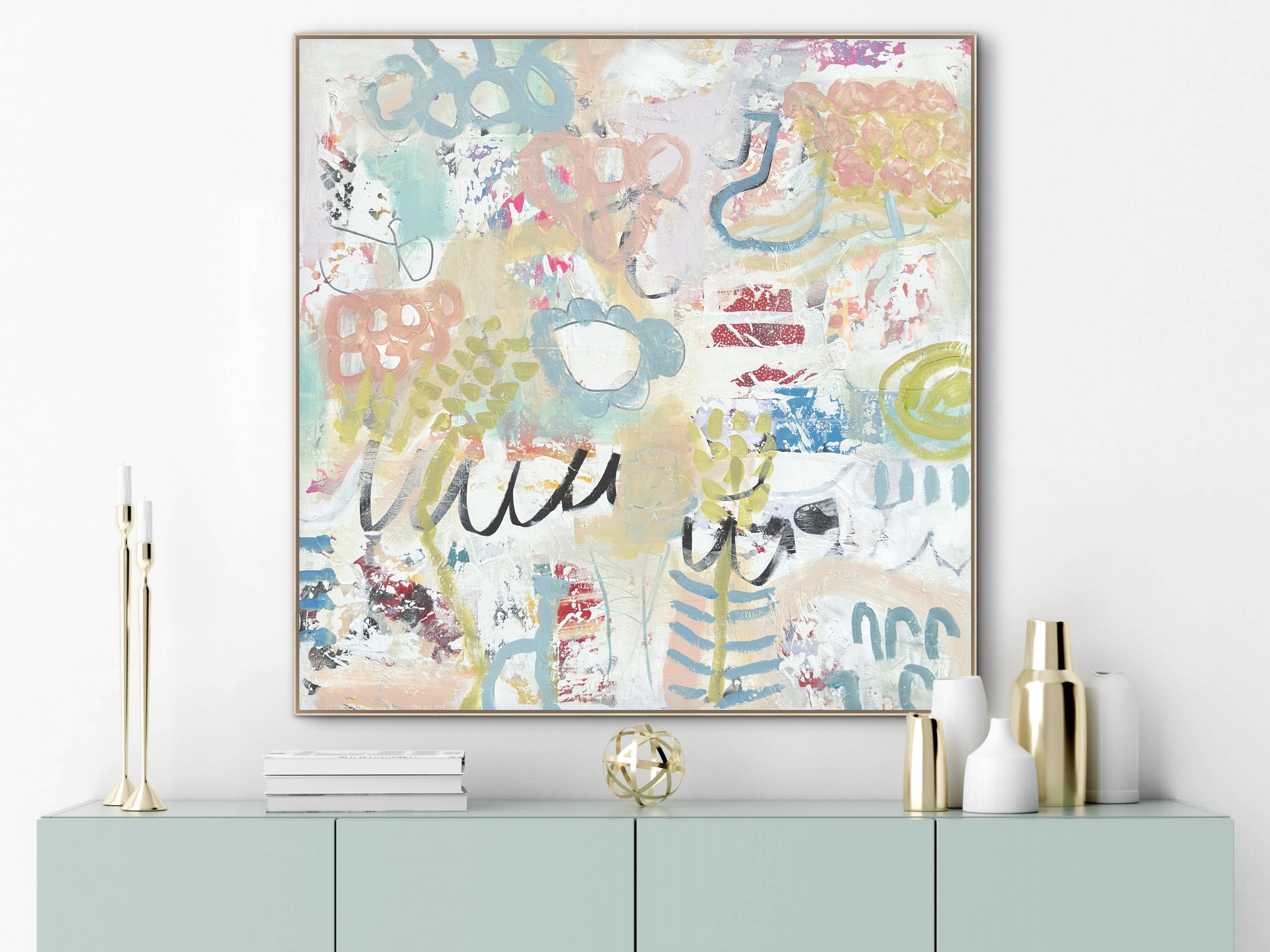 Abstract mixed-media painting by Elizabeth Williams displayed above a pale green console table with gold decorative objects.