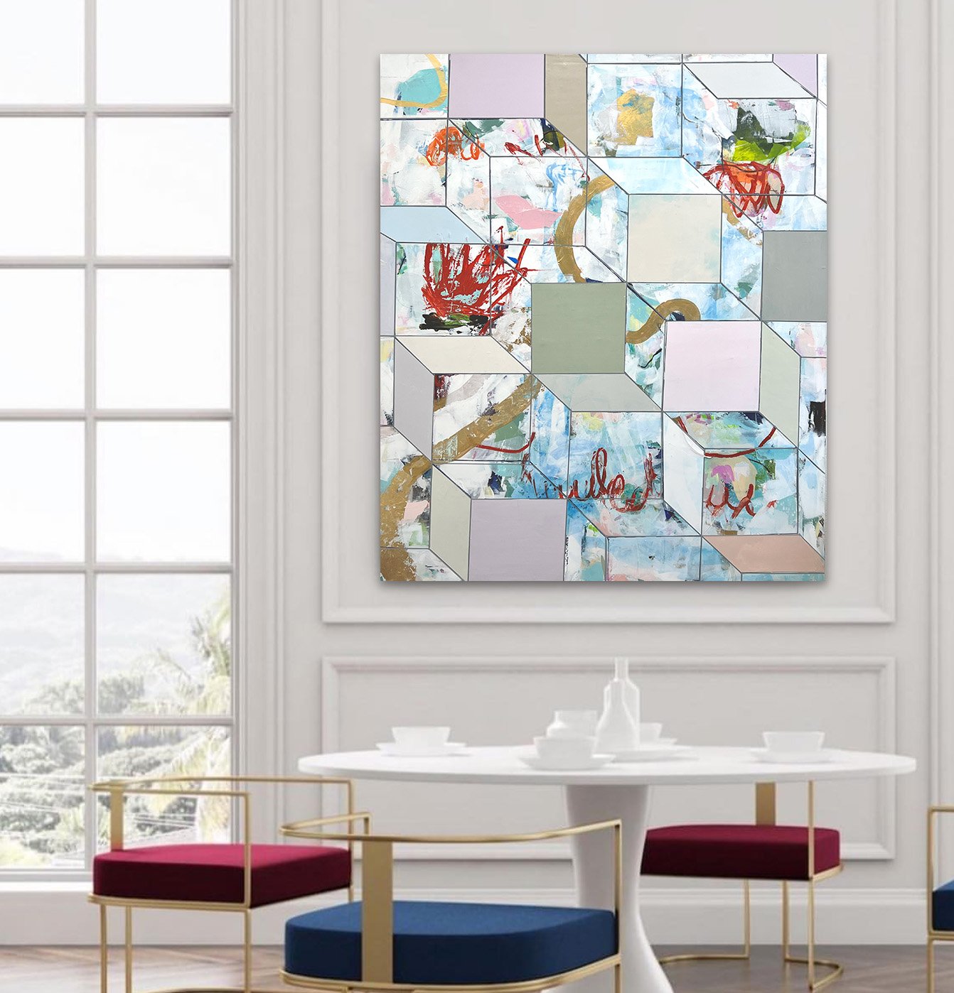 Decorative abstract art piece on a wall in a bright room with a large window, white walls, white table, and colorful chairs with gold accents.