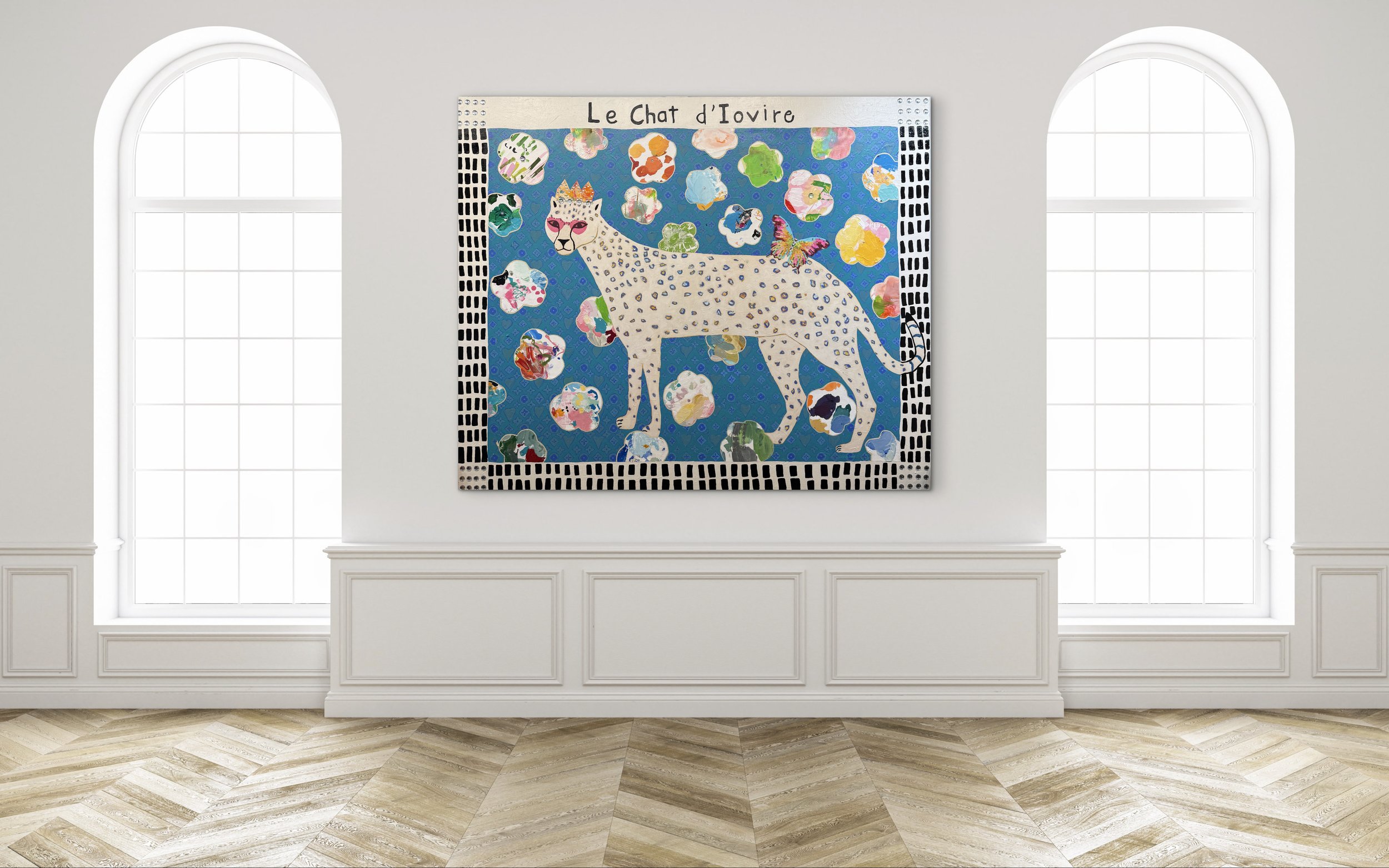In-room mockup of Le Chat d’Ivoire, a 60x72 mixed media painting of a crowned white spotted cat on a blue patterned background with colorful shapes and a butterfly.