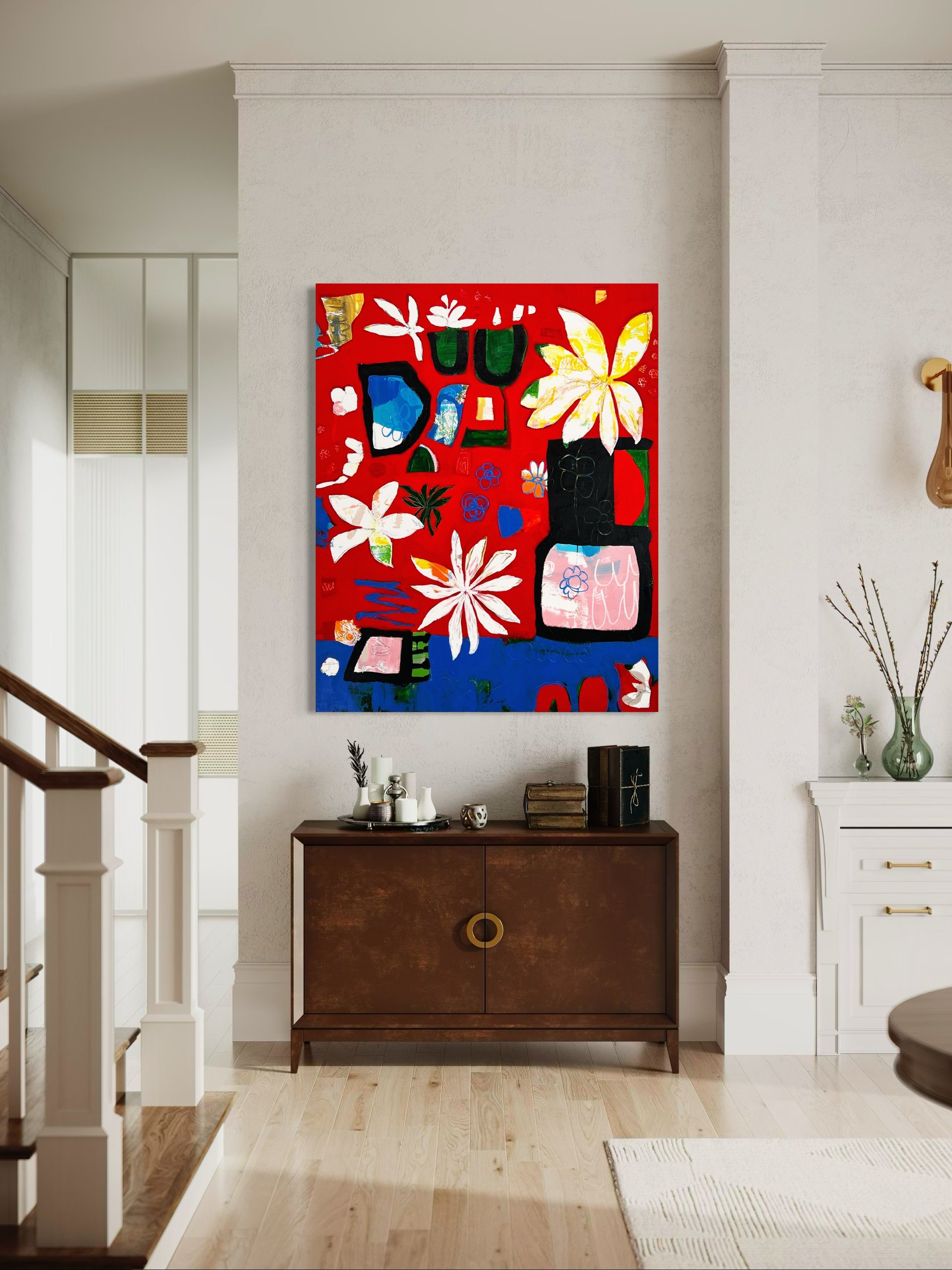 A living room area featuring a colorful abstract painting of flowers on a red background hanging on a white textured wall above a mid-century modern brown wooden cabinet. The cabinet has decorative items on top, including small vases and books. To th